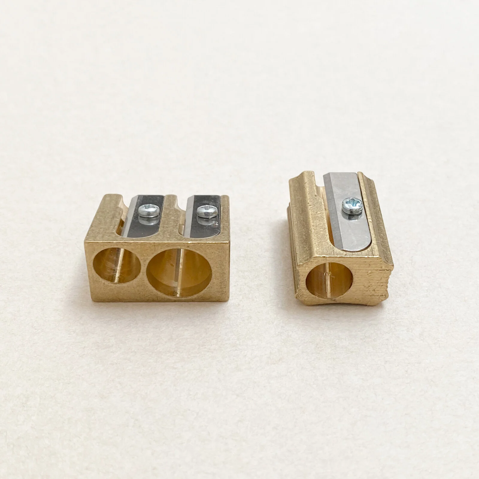 Solid brass pencil sharpeners by DUX with visible sharpening barrels, made in Germany