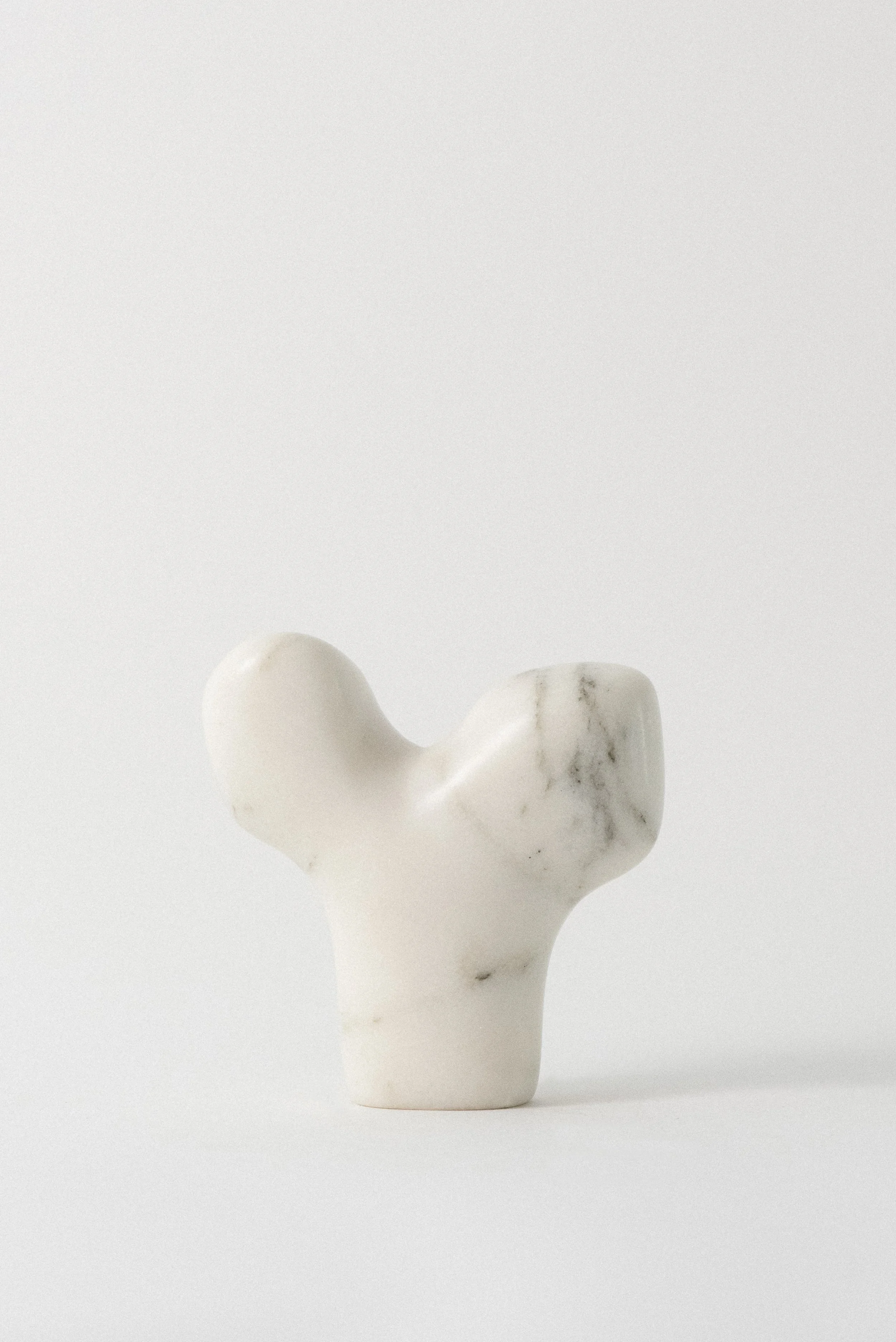 White marble sculpture ‘Bone’ hand-carved modern art piece by Kevin Noordberg