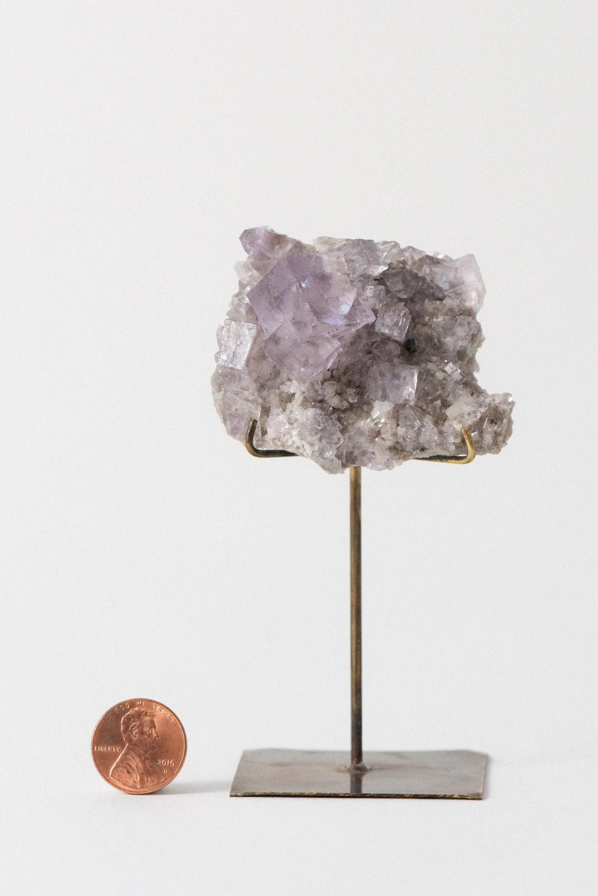 Shot of fluorite and dolomite crystal specimen on patinaed brass base