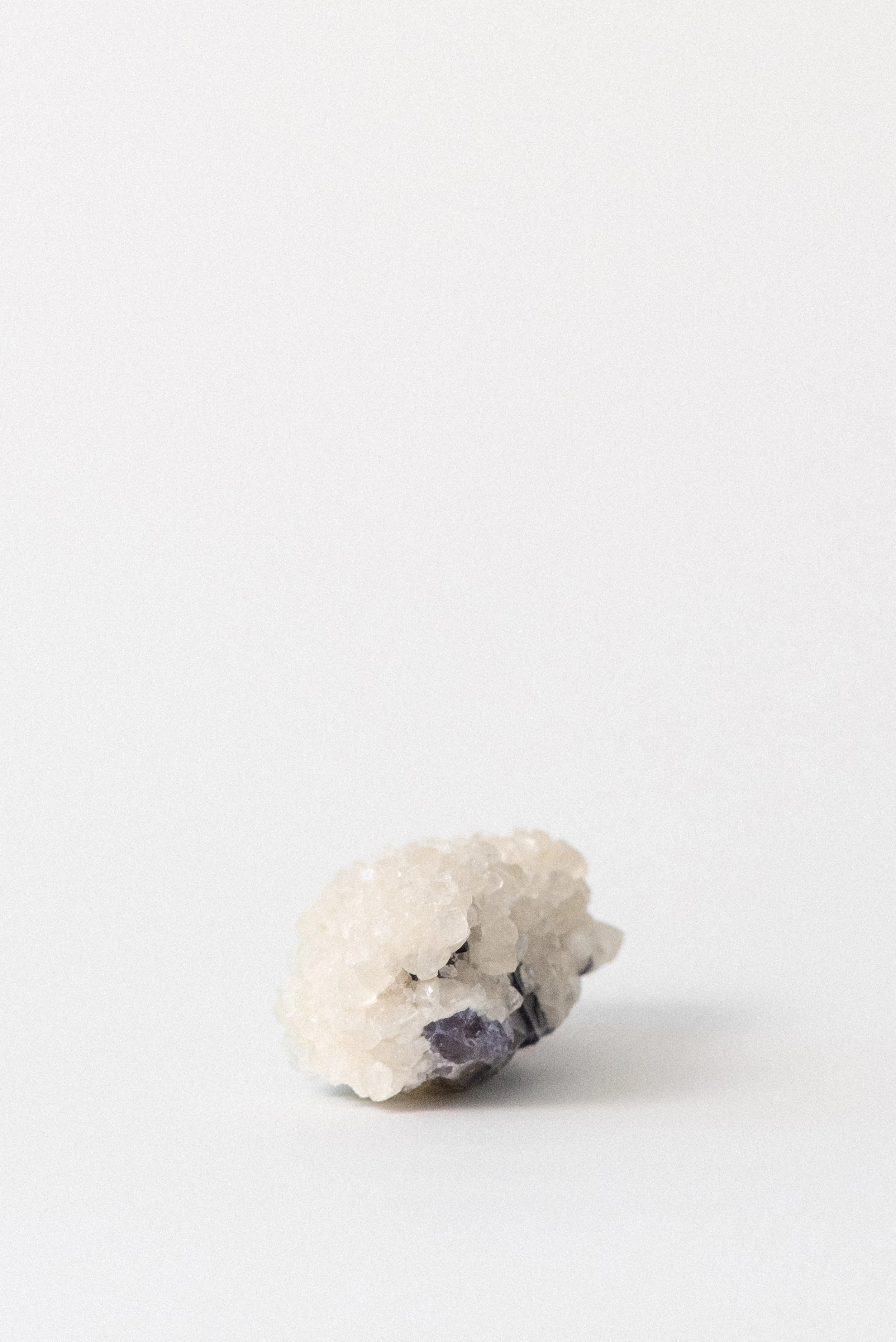 side profile of calcite perched on deep purple fluorite matrix from Hardin County, IL