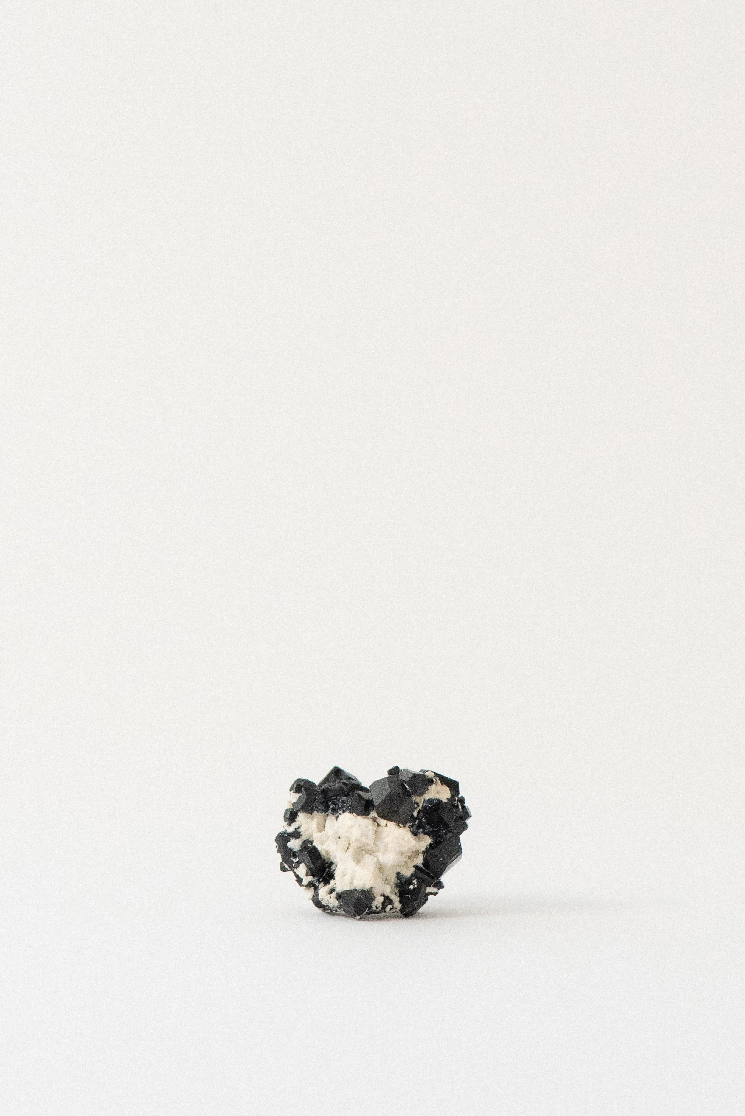 Black tourmaline cluster with stark white matrix from Erongo Mountain, Namibia, featuring sharply defined crystal formations.
