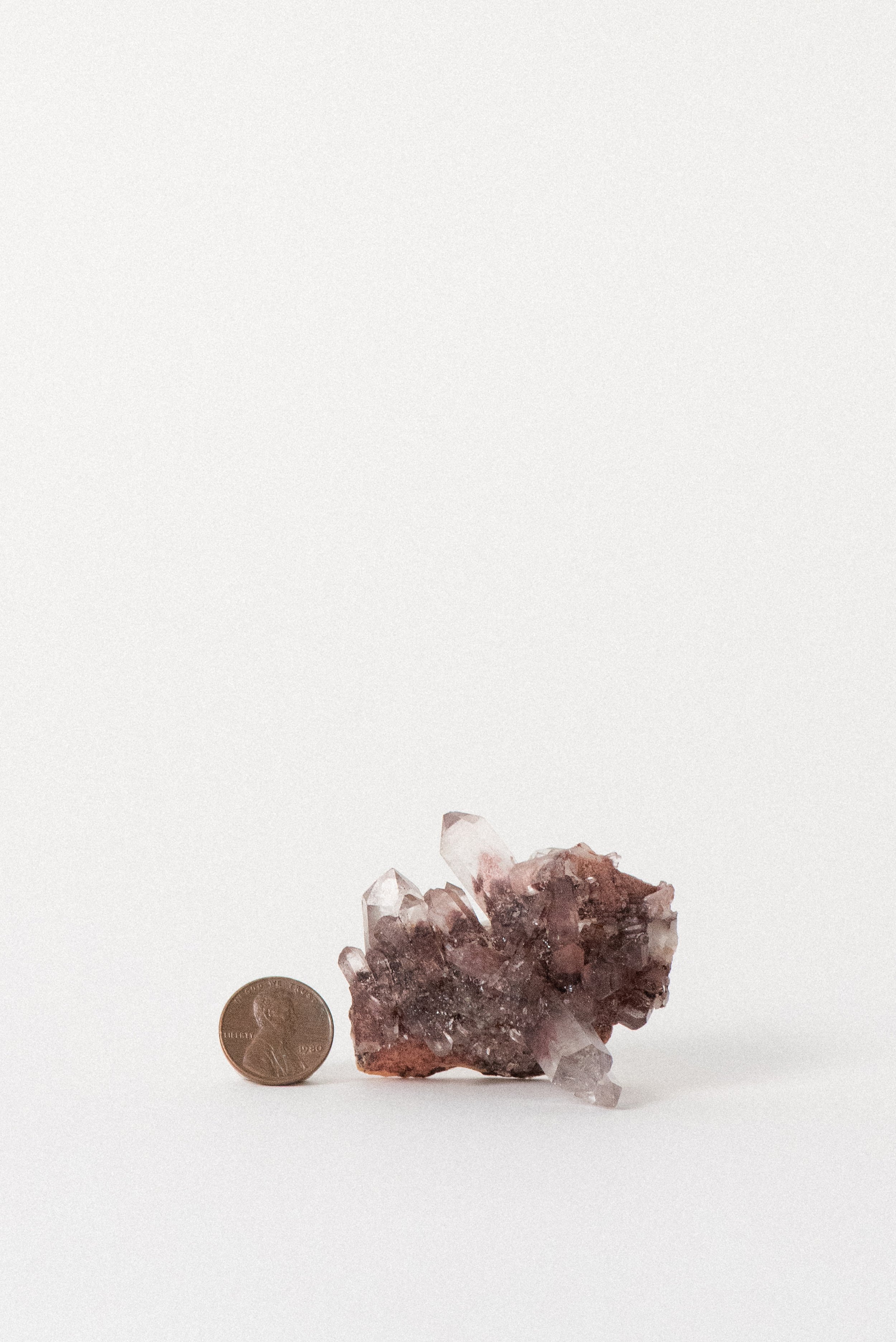 Cluster with penny for scale, showing orange phantom inclusions