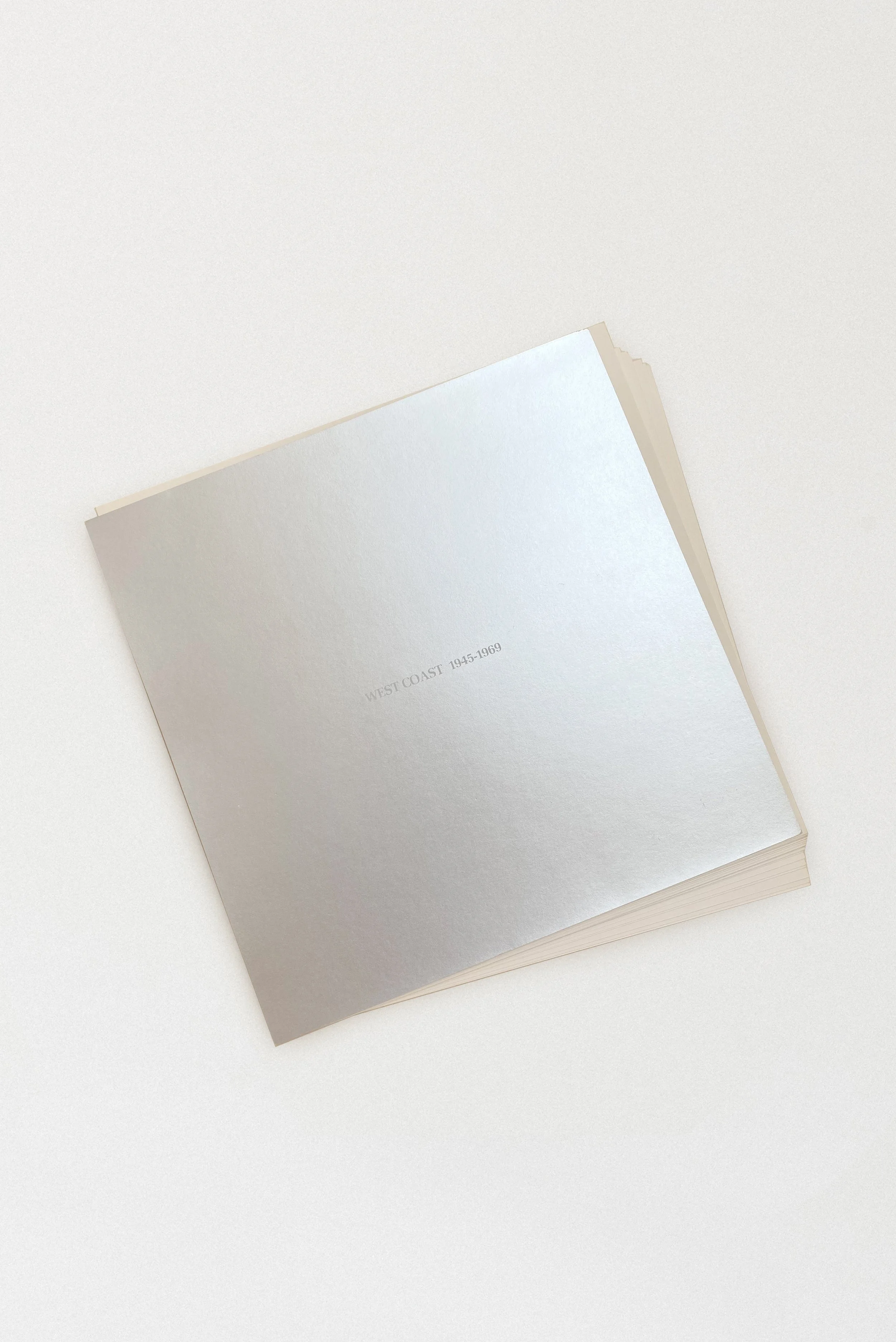 Interior title page of the West Coast: 1945–1969 exhibition catalog from the Pasadena Art Museum, showing the silver-toned cover of the loose-leaf portfolio edition.