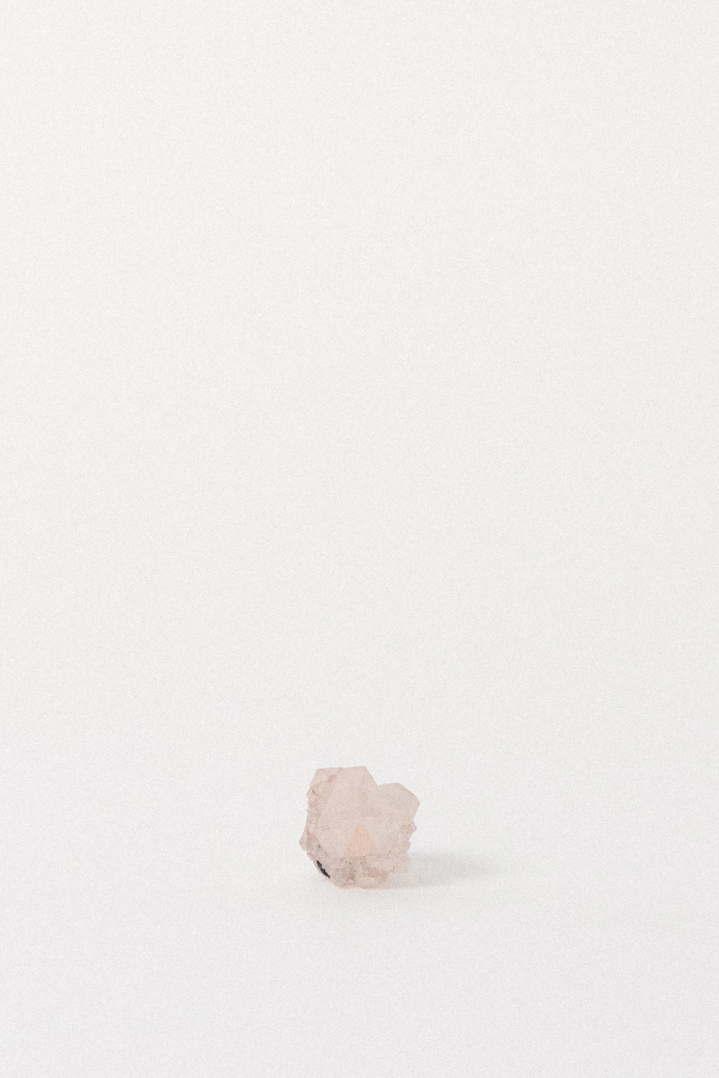 Quartz cluster highlighting pink hematite coloration and purple fluorite accent