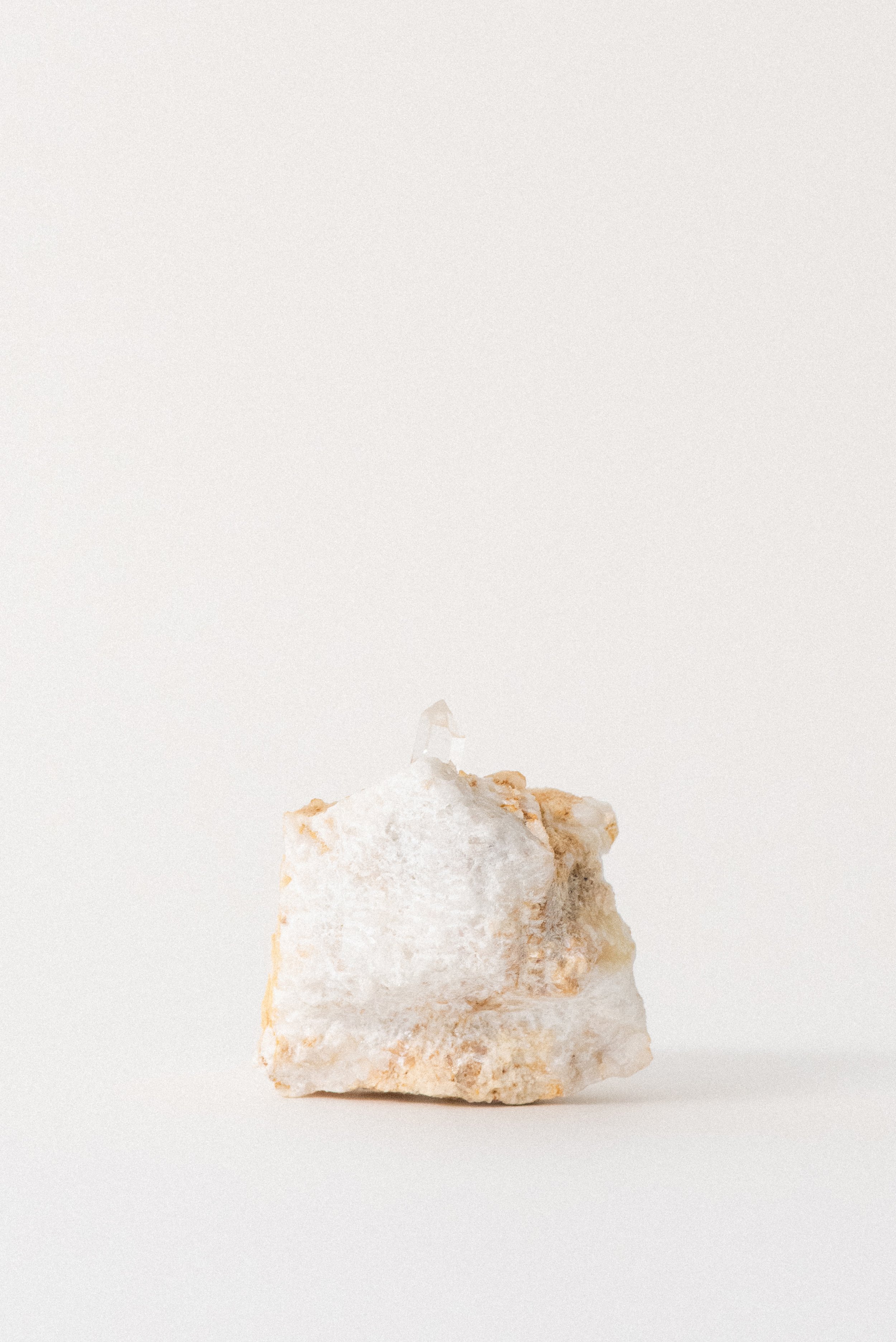 Back view of quartz crystal on Carrara marble matrix from La Facciata Quarry, highlighting the stone’s natural texture and mineral contrast, photographed for Crystal Voyager.