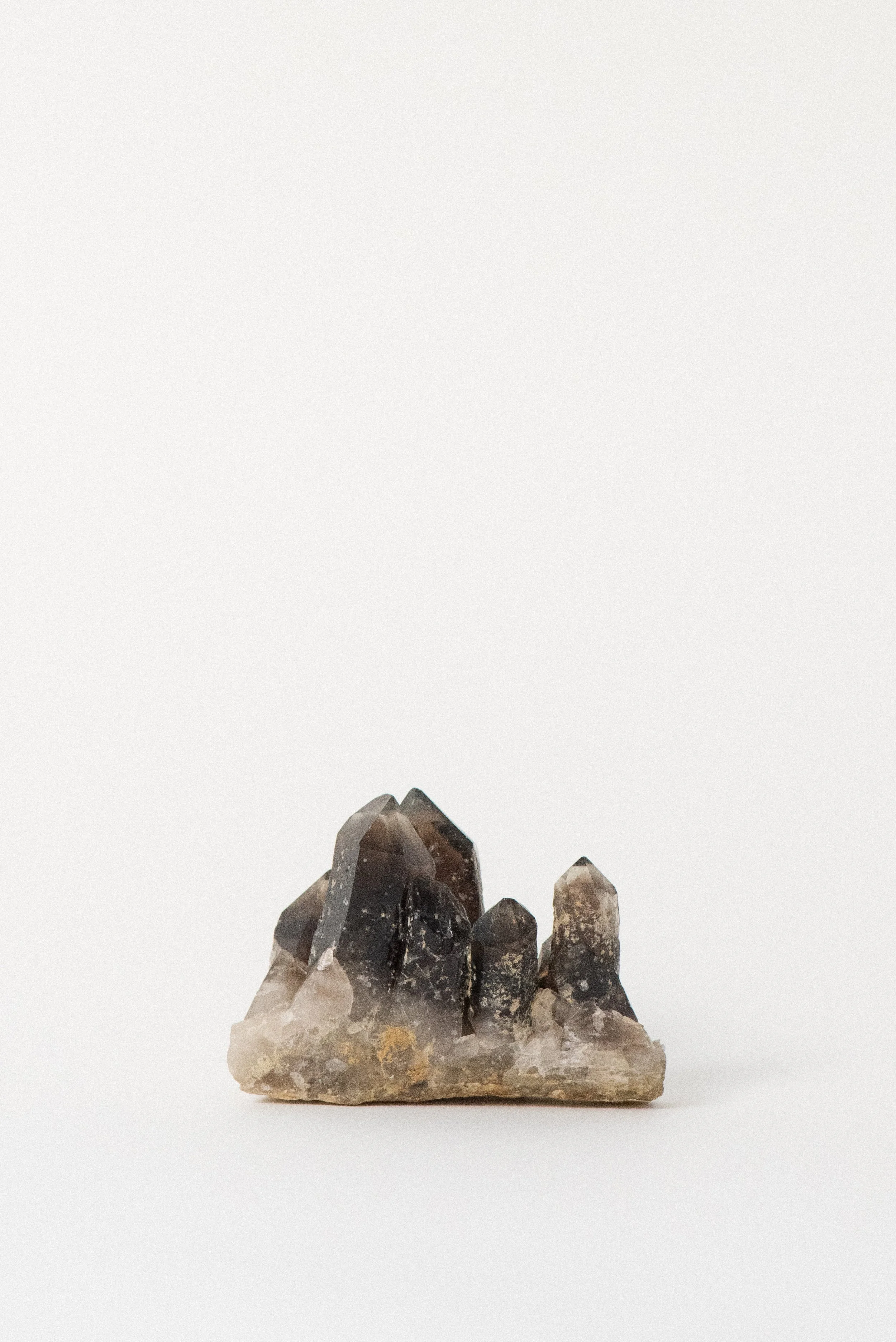 Multi-point smoky quartz crystal with black inclusions from Hallelujah Junction, California–Nevada.