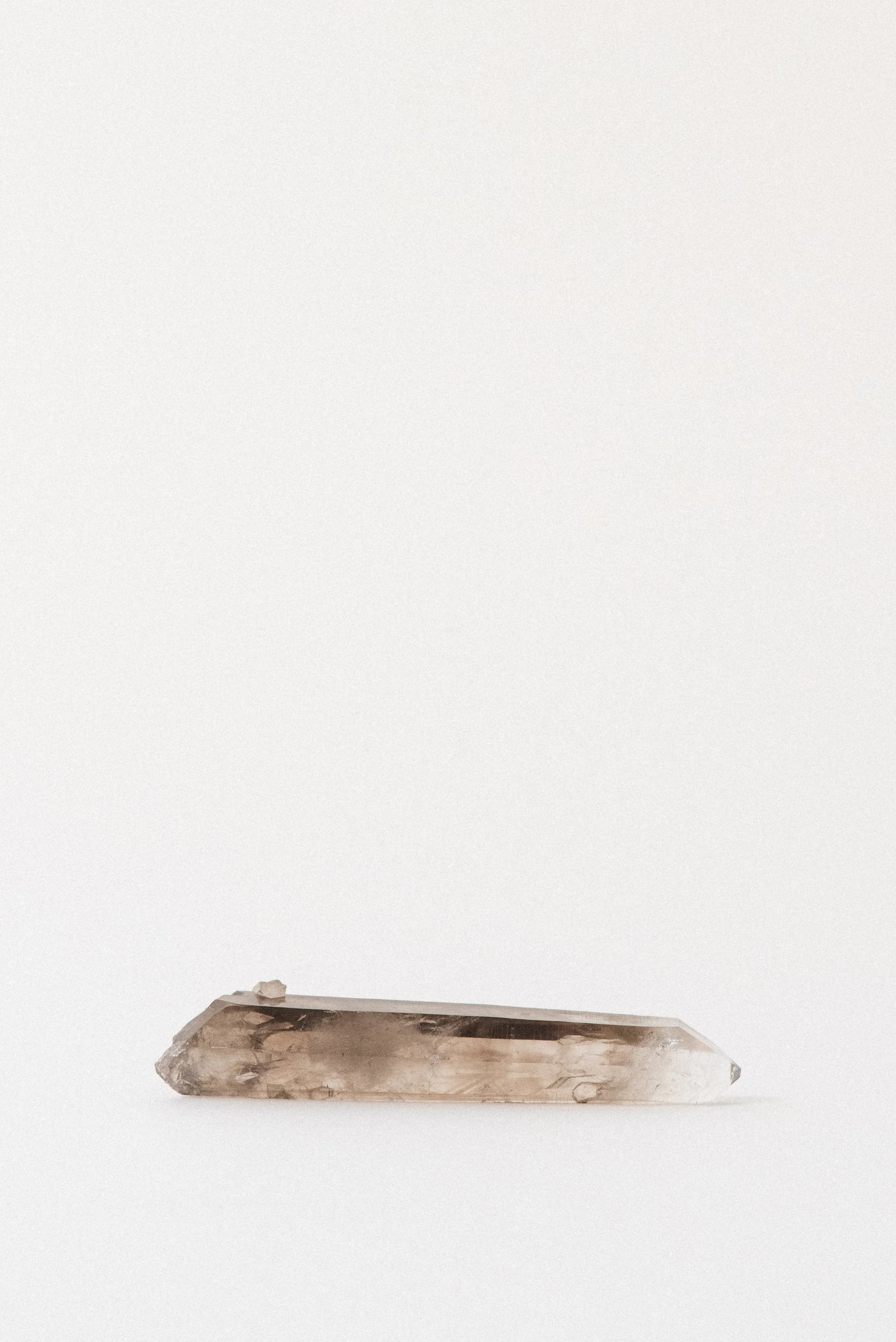 Clear smoky quartz point with visible phantoms from Lincoln County, New Mexico.
