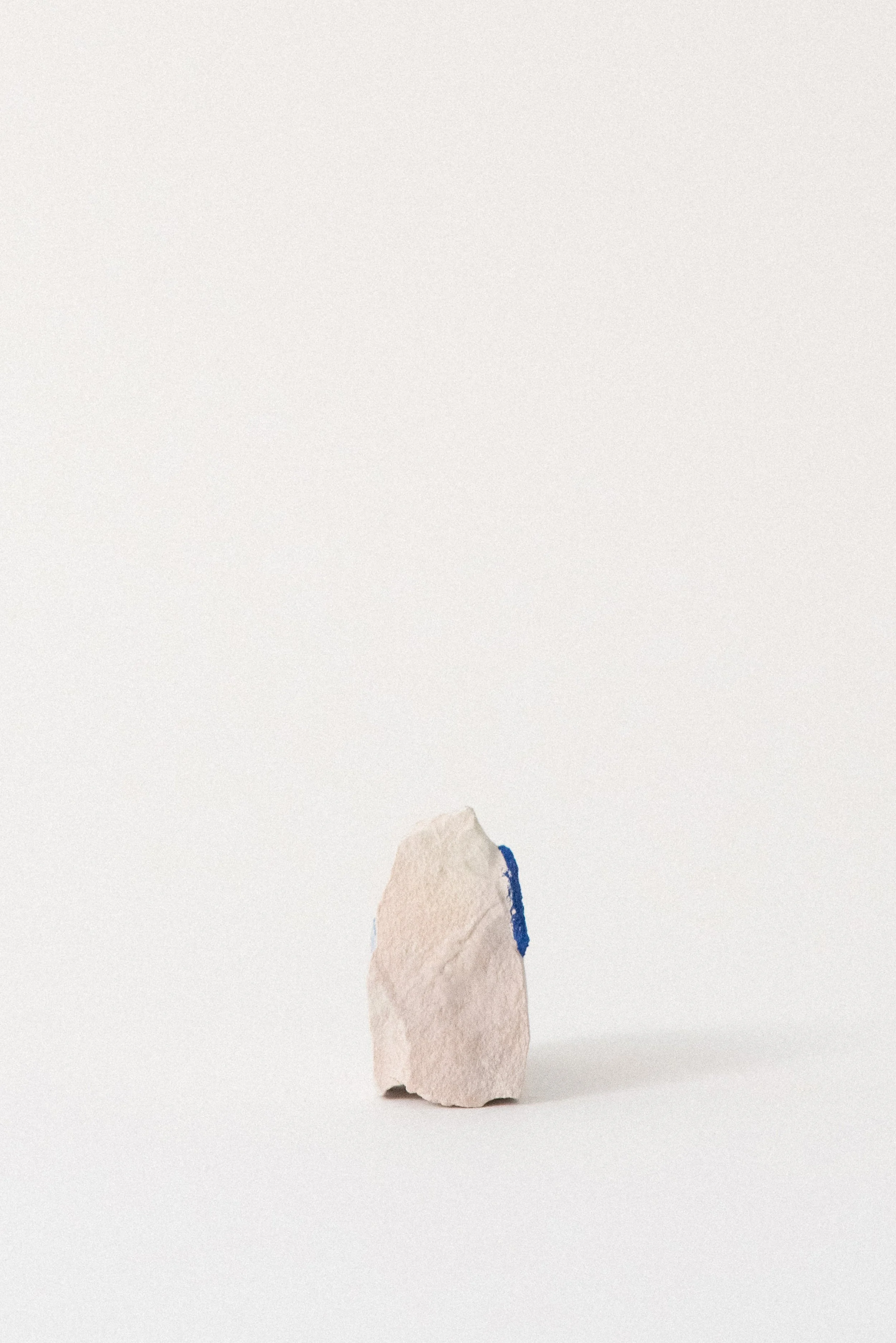 Side view of an azurite sun partially visible on a pale clay matrix, from Malbunka Copper Mine in the Northern Territory of Australia.