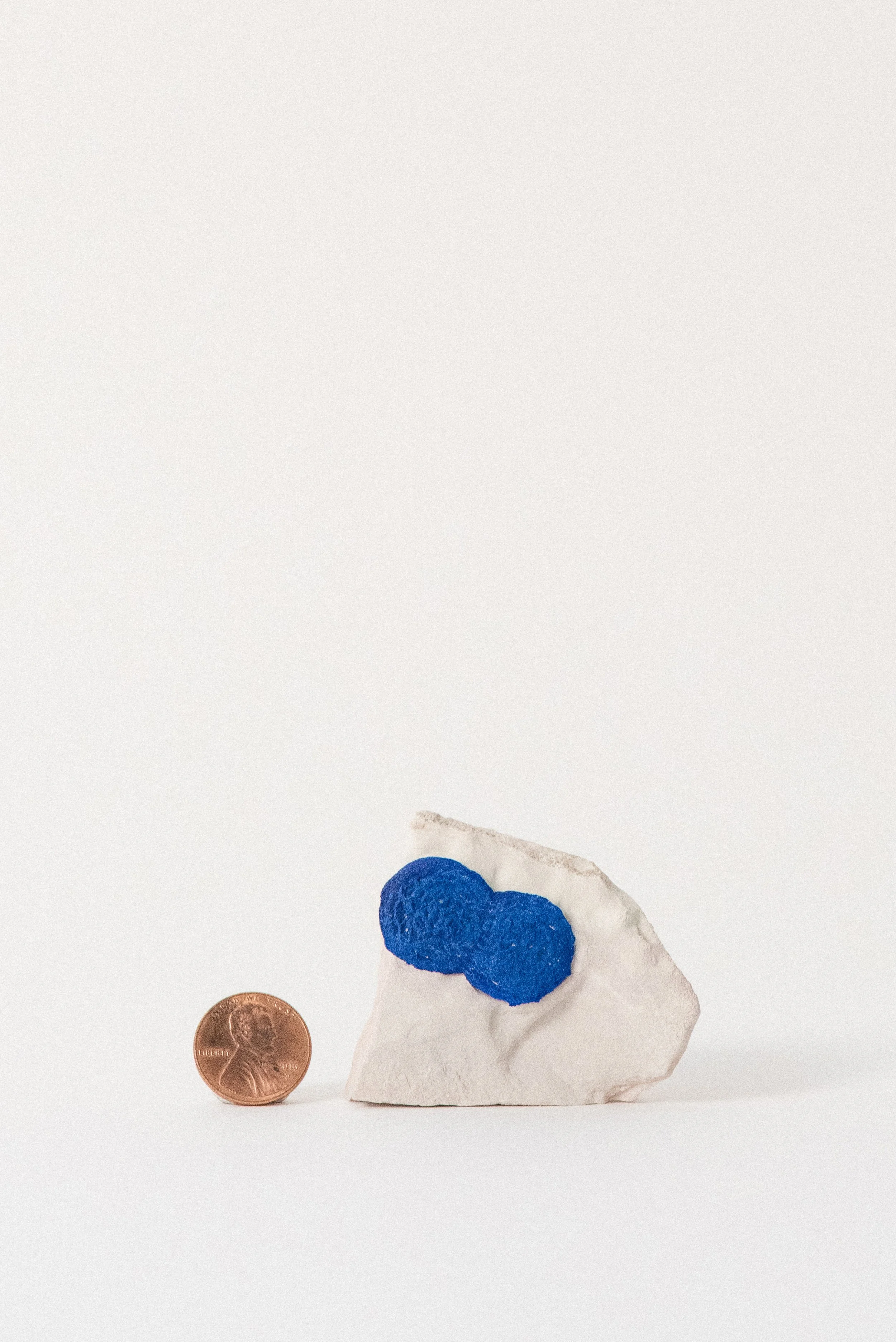 Azurite crystal rosette on pale clay matrix from Malbunka Copper Mine, Gardiner Range, Northern Territory, Australia, shown with a penny for scale, photographed for Crystal Voyager.