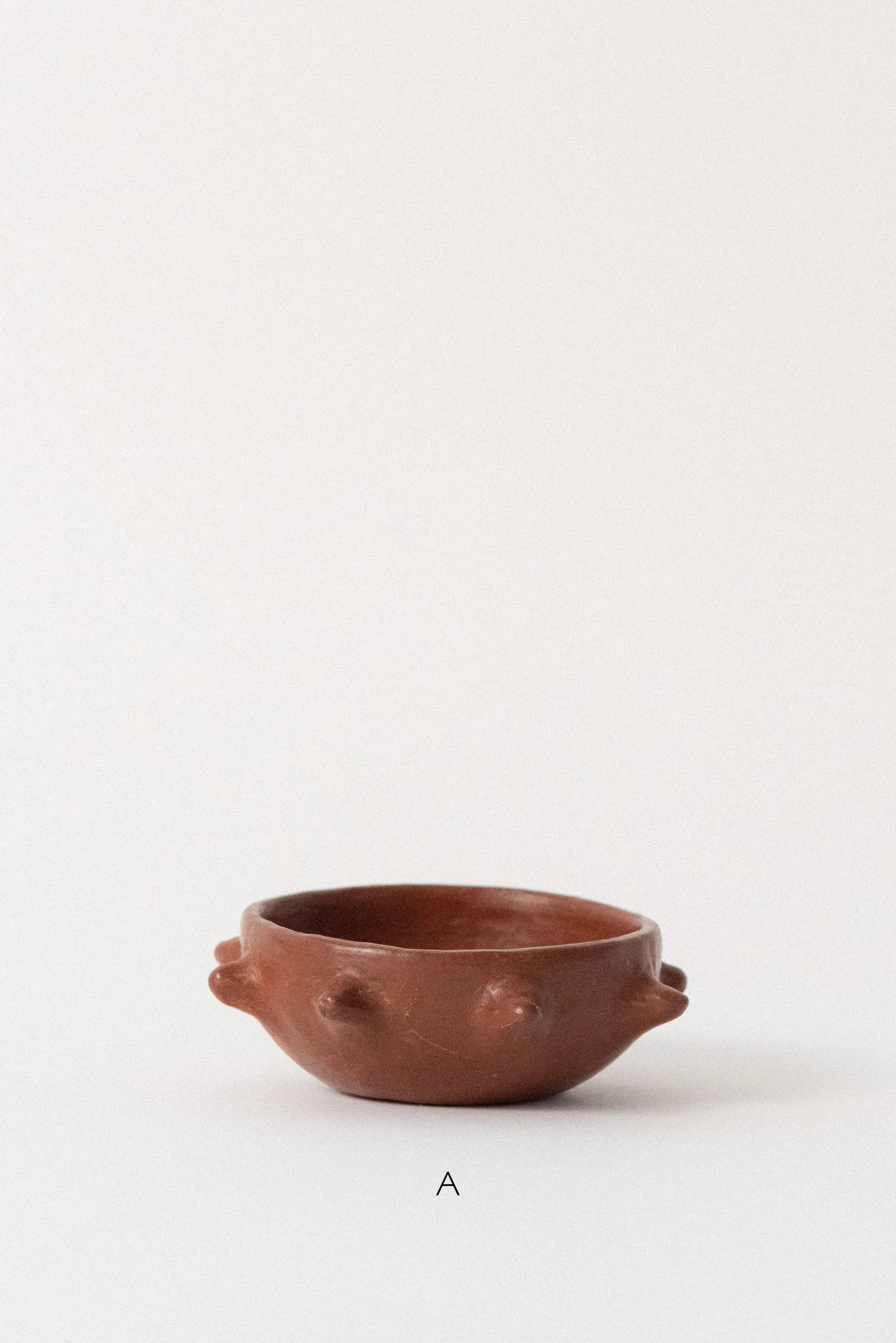 Handmade barro rojo bowl from Oaxaca with three sculpted spike accents and a warm, burnished finish.