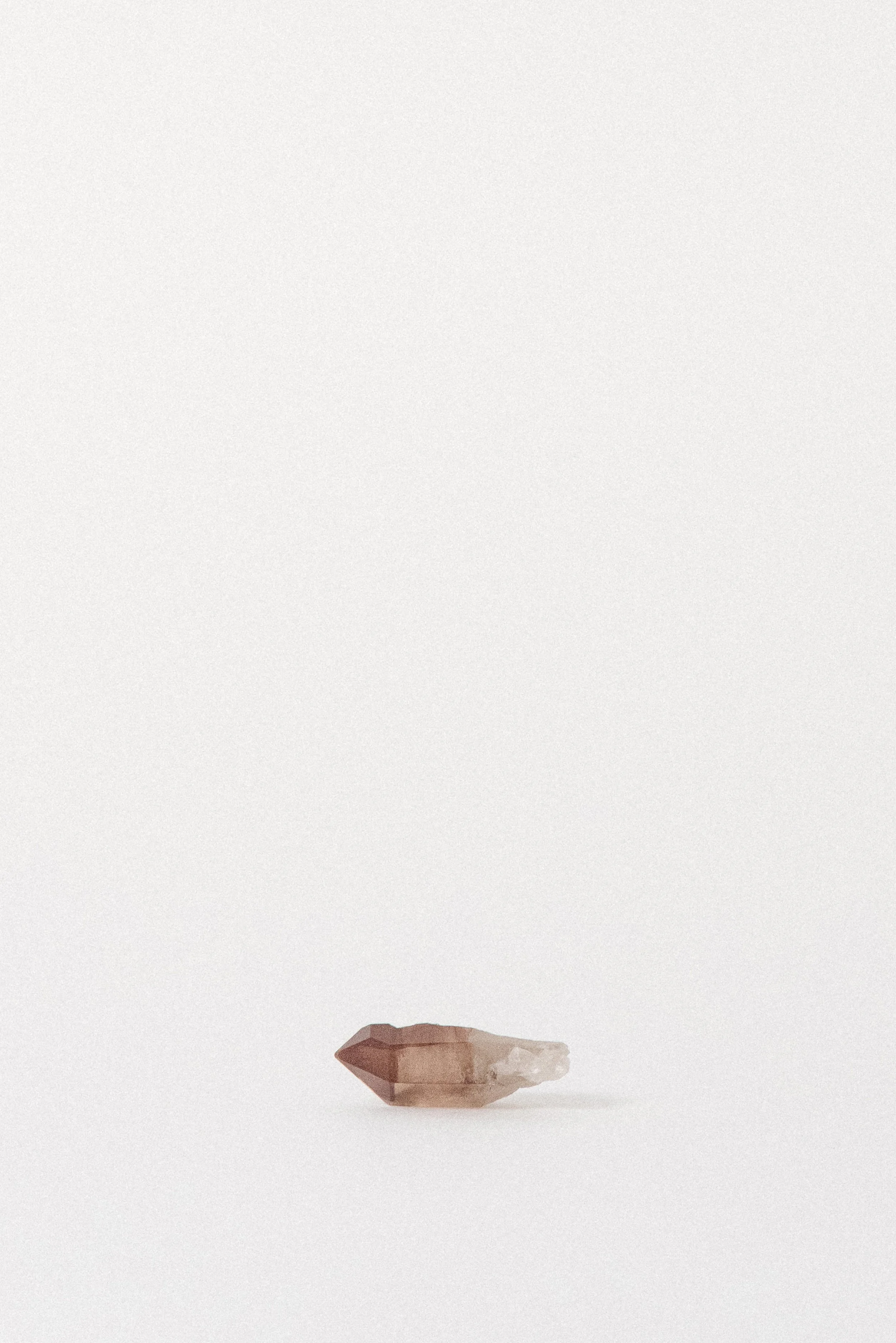 Side profile of Red Quartz point showing reddish hue and clarity.