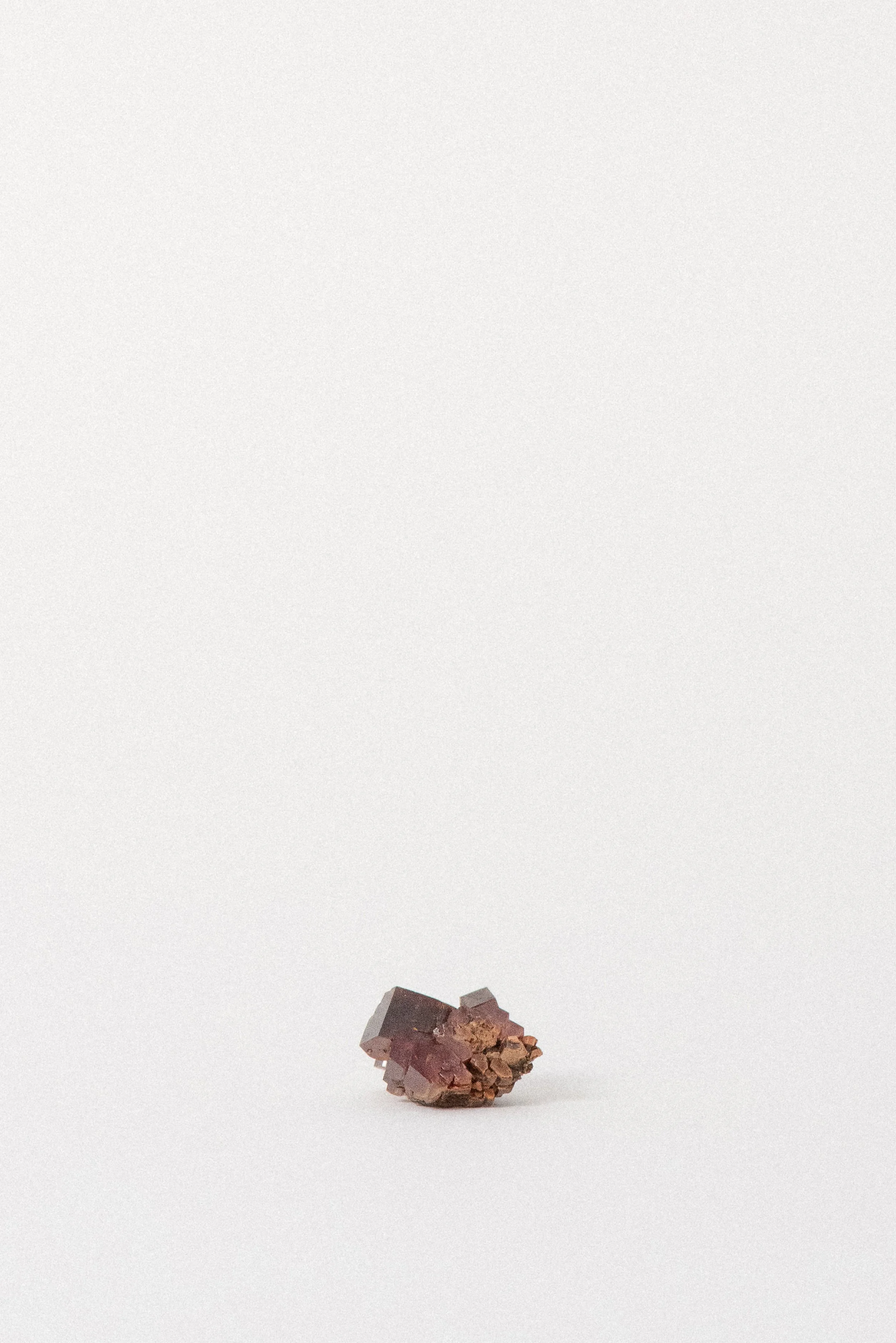 Back view of Vanadinite cluster with metallic sheen and red-orange tones.