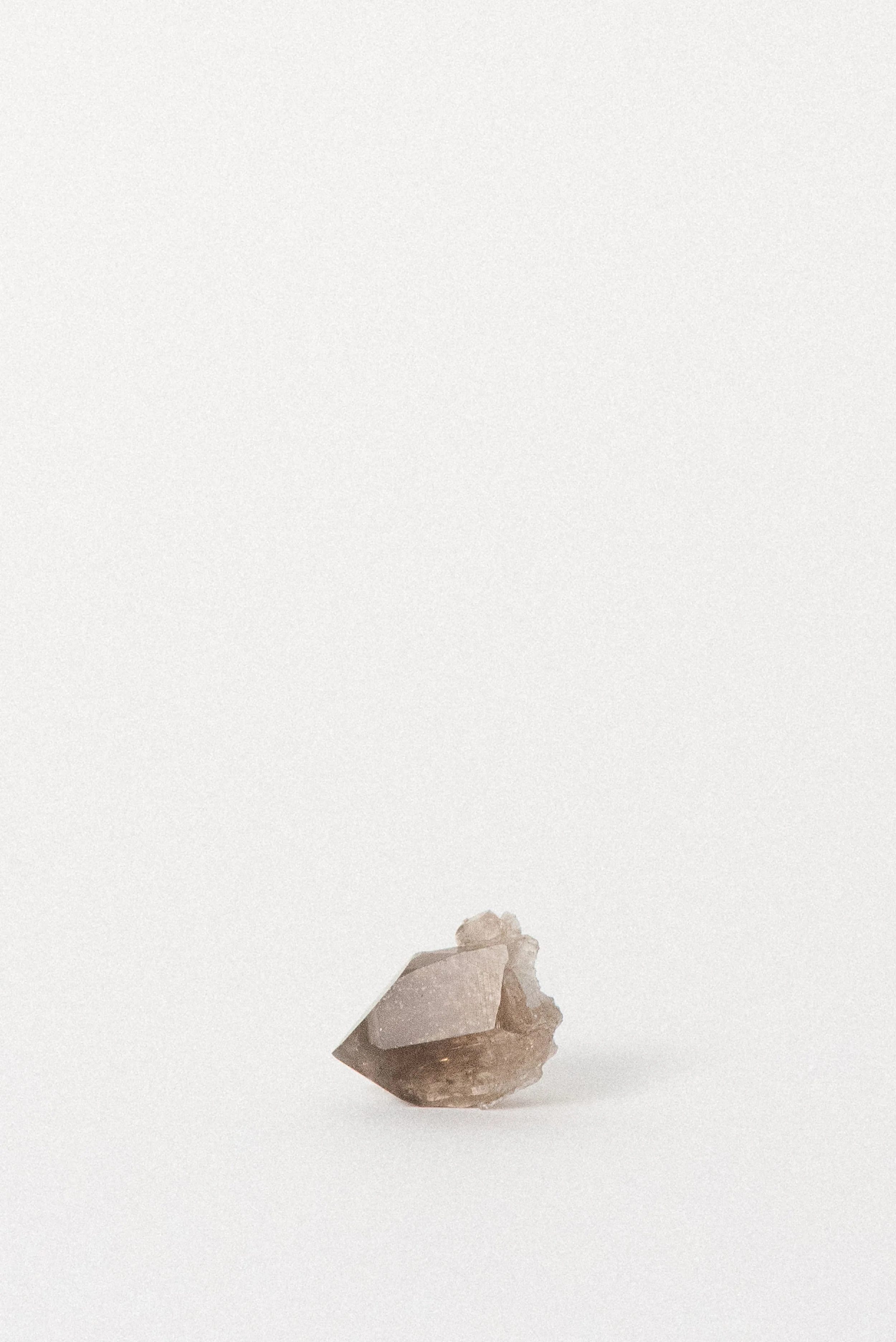 Side view of smoky quartz crystal with natural matrix from Chamonix, ethically sourced in Europe.