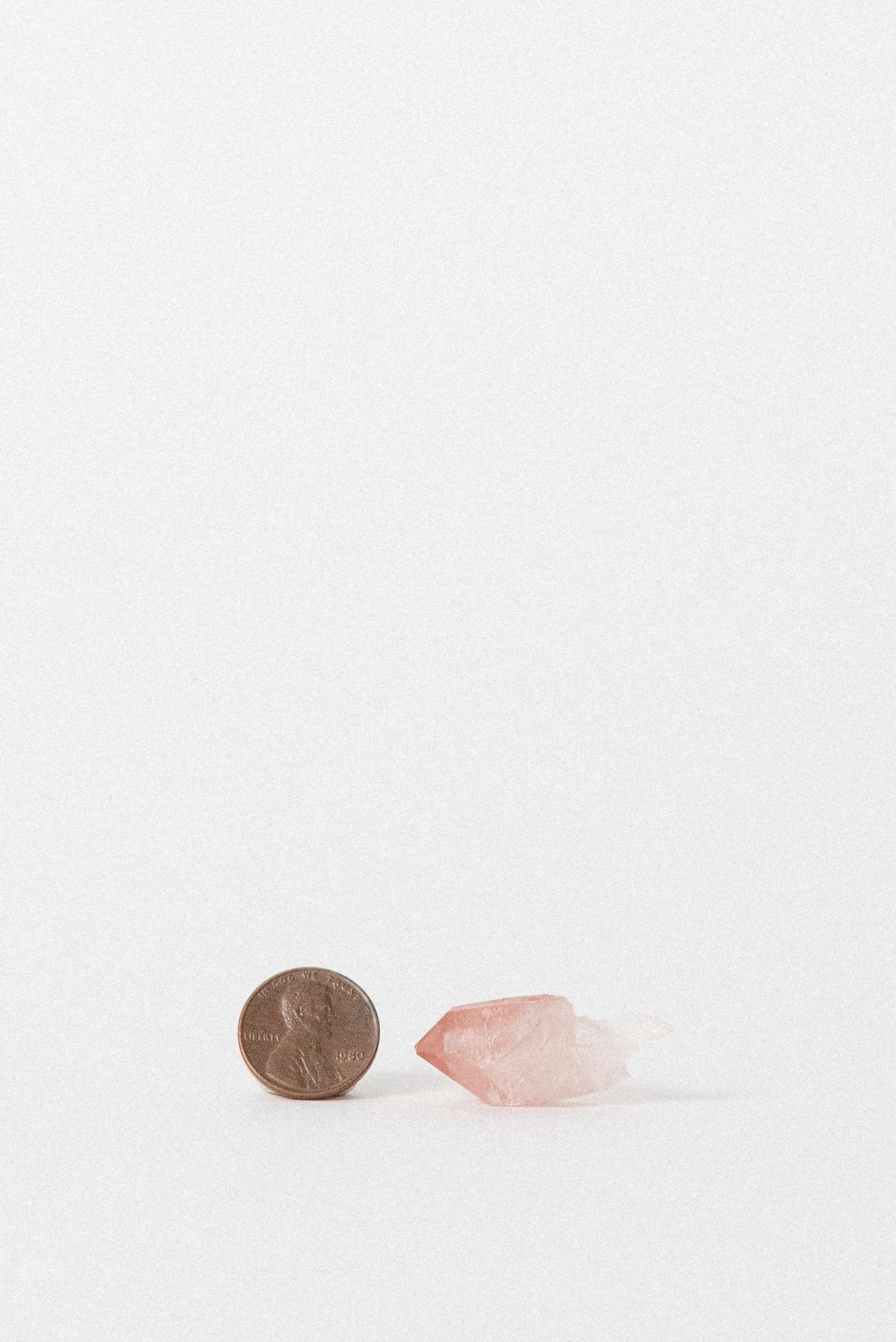 Pink Quartz next to a penny for scale, from Bharatpur, India.