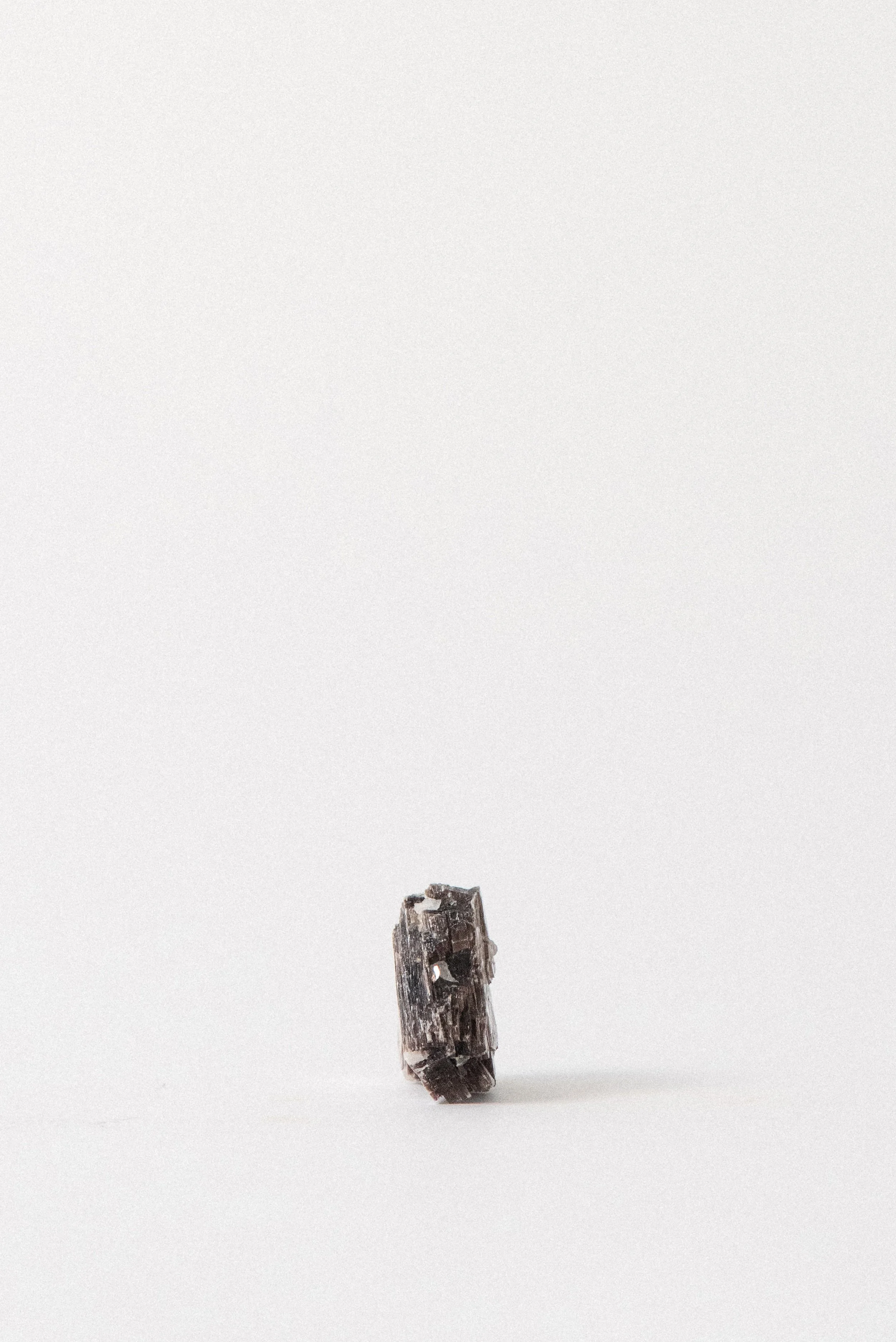 Side view of a muscovite mica specimen from Taquaral, Minas Gerais, Brazil. Displays the stone’s silvery-brown, layered sheet structure and natural shimmer. From the Crystal Voyager collection.