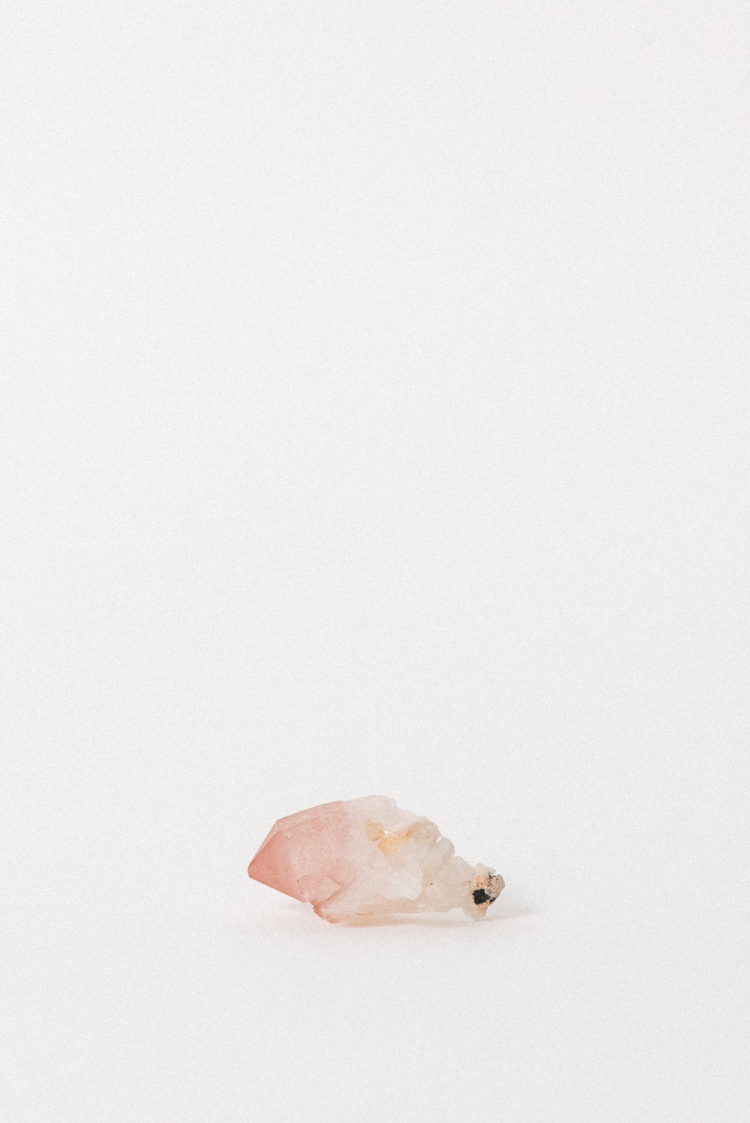 Hematite-included Pink Quartz crystal from Bharatpur, Rajasthan, showing soft gradient from rose to white.
