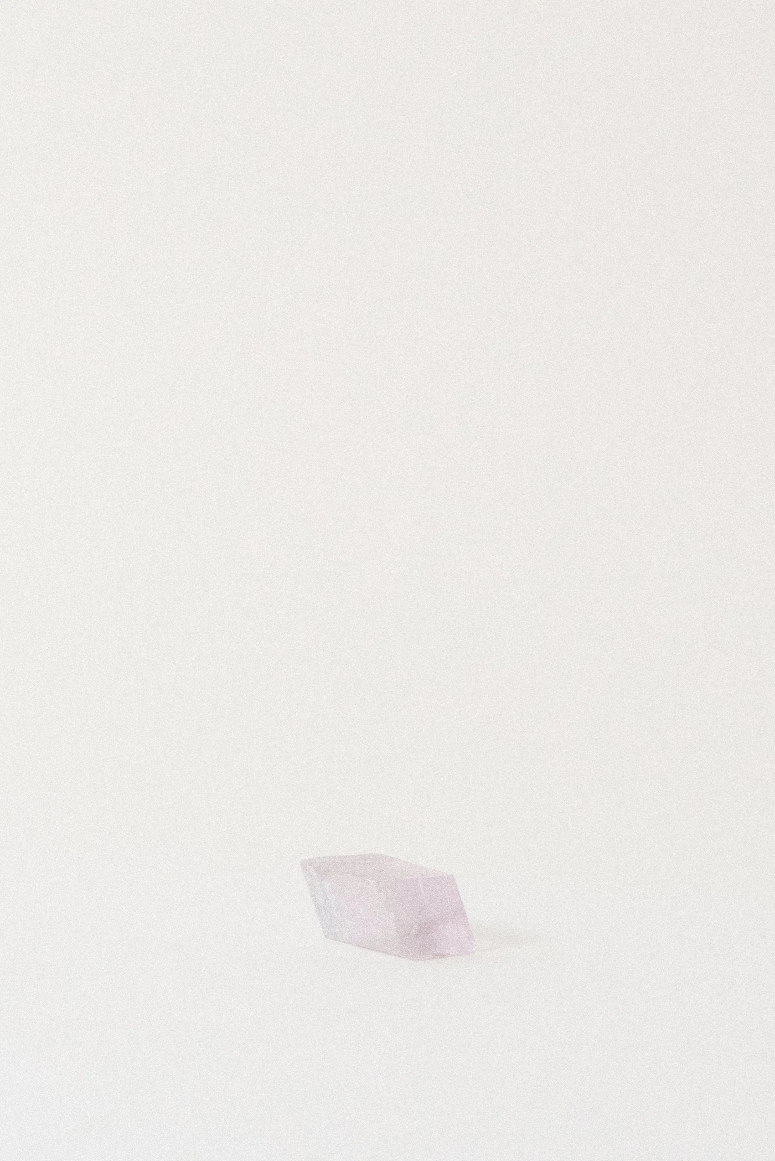Lavender Balmat Calcite crystal from Balmat, New York, photographed from the back corner angle to highlight its natural rectangular shape and translucent lilac tone.
