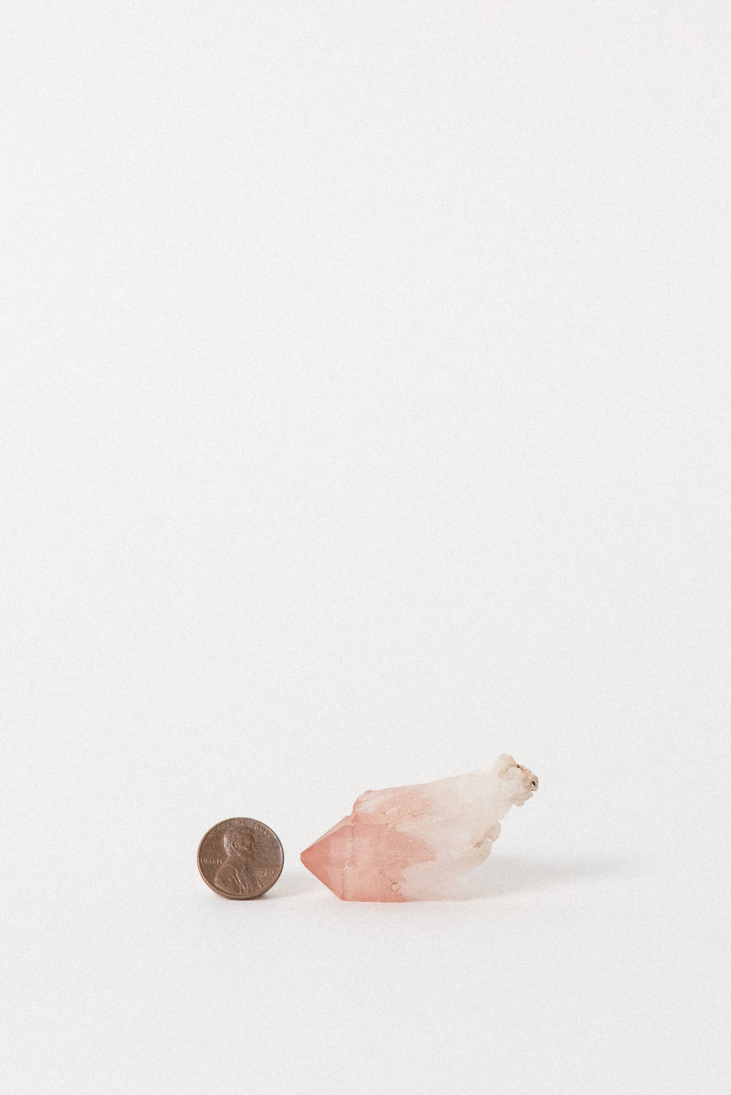 Pink Quartz crystal with penny for scale, from Bharatpur, India
