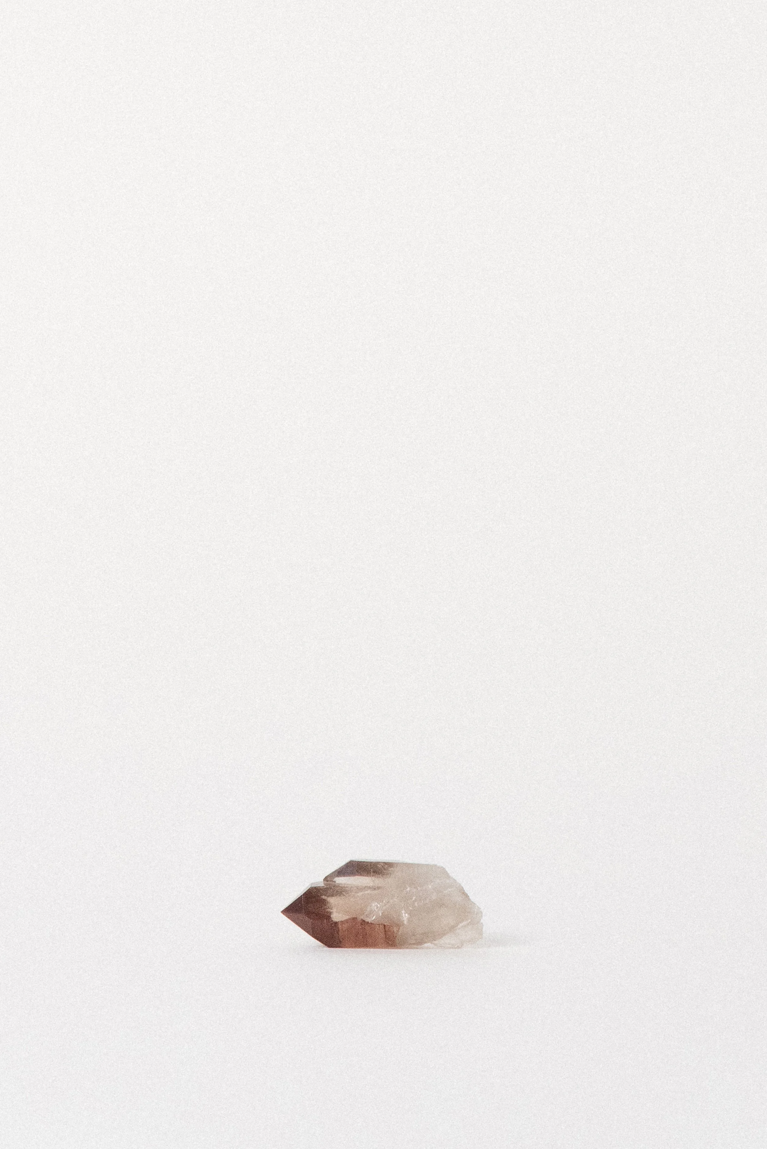 Angled view highlighting the natural red iron oxide zoning in Quartz.