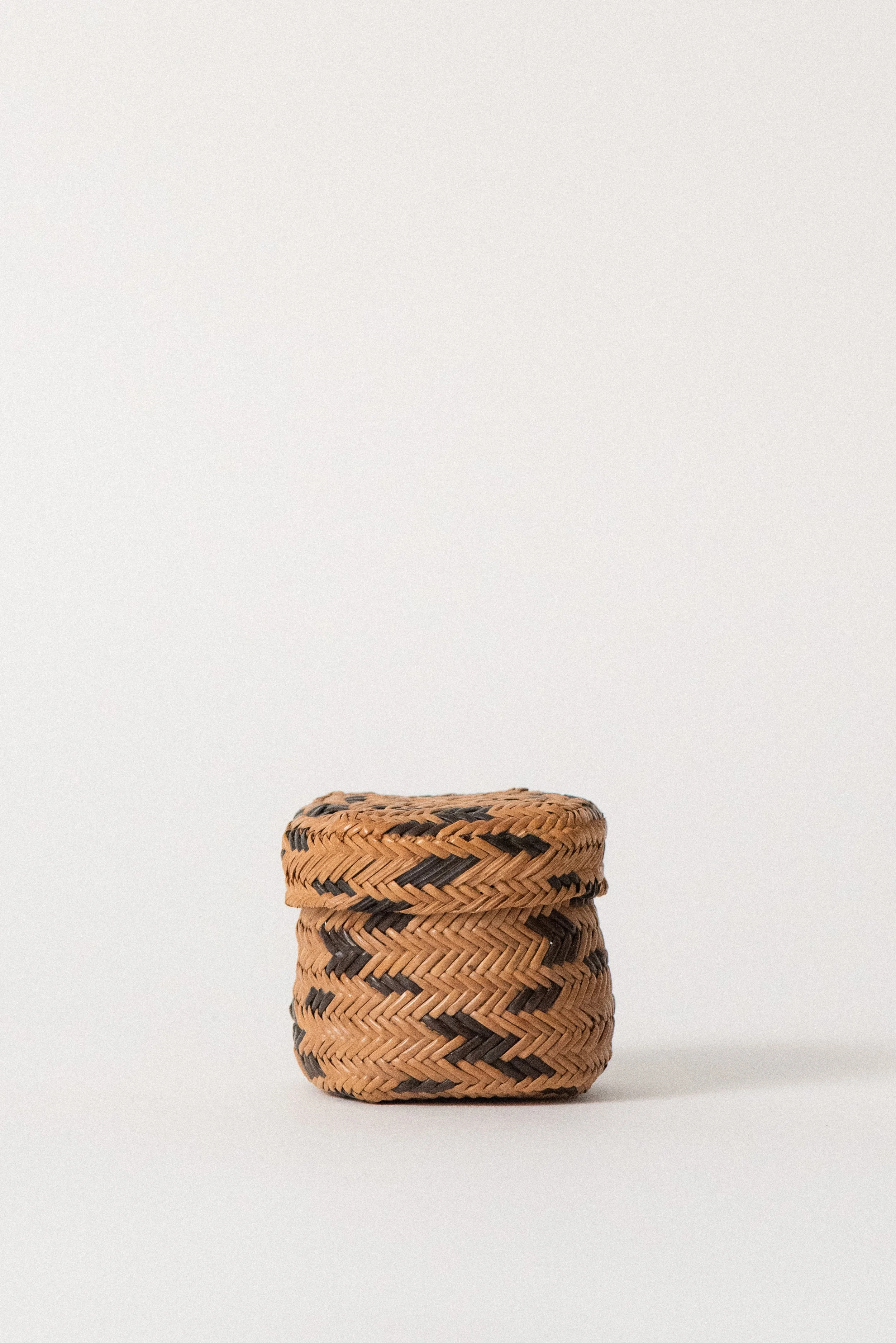 Handwoven Tarahumara basket from Mexico, showing side angle of vintage 1960s pine needle construction.