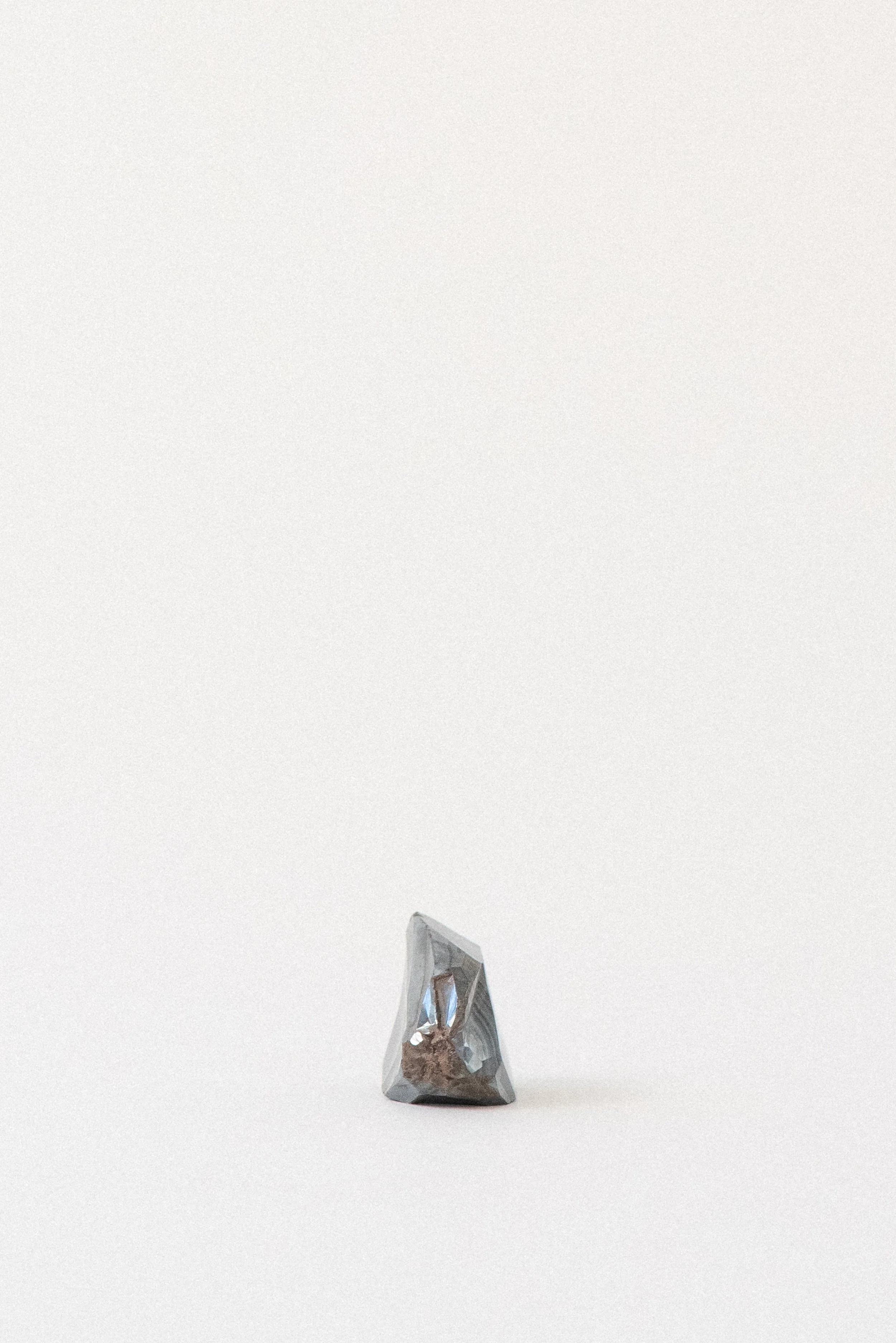 Side highlighting the smooth, metallic surface of botryoidal hematite for grounding energy
