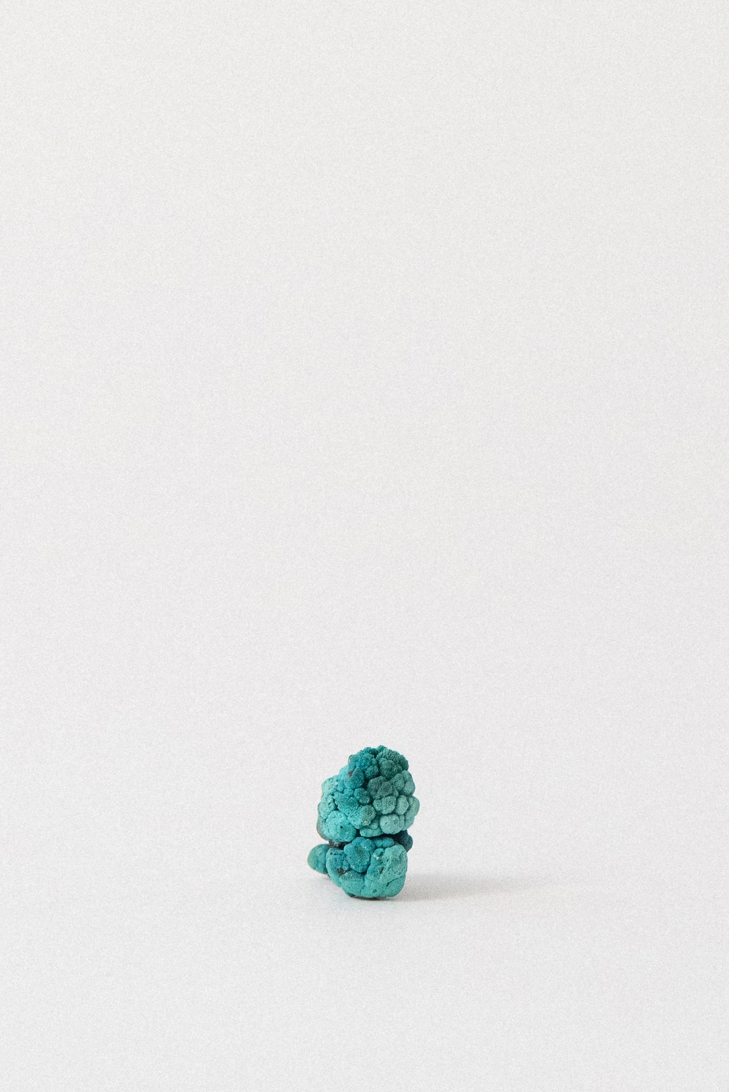 Chrysocolla pseudomorph after Malachite specimen in upright view from Planet Mine, Arizona, displayed on a white background.
