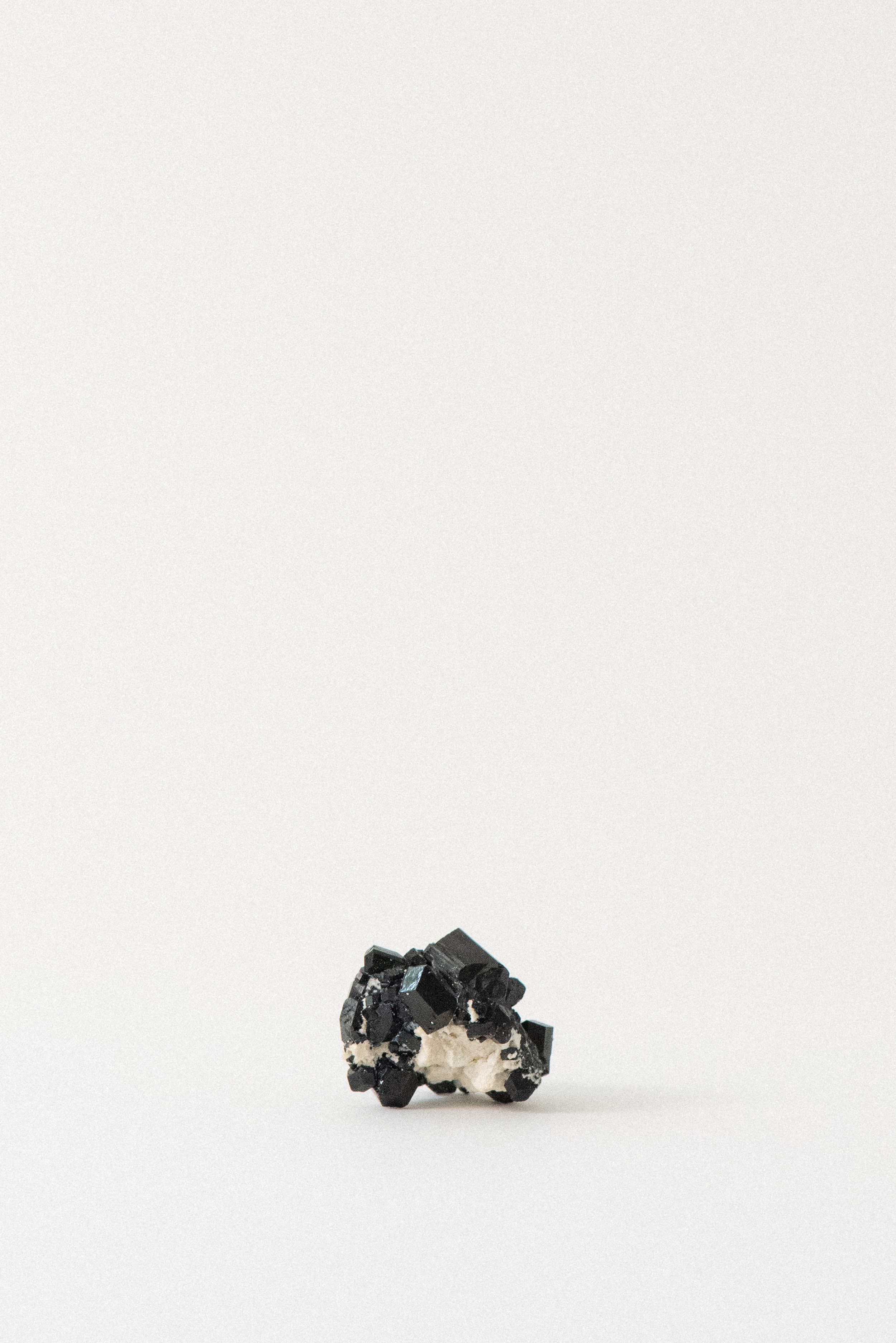 Black tourmaline crystal cluster with visible matrix from Erongo Mountain, Namibia, showcasing lustrous geometric terminations.