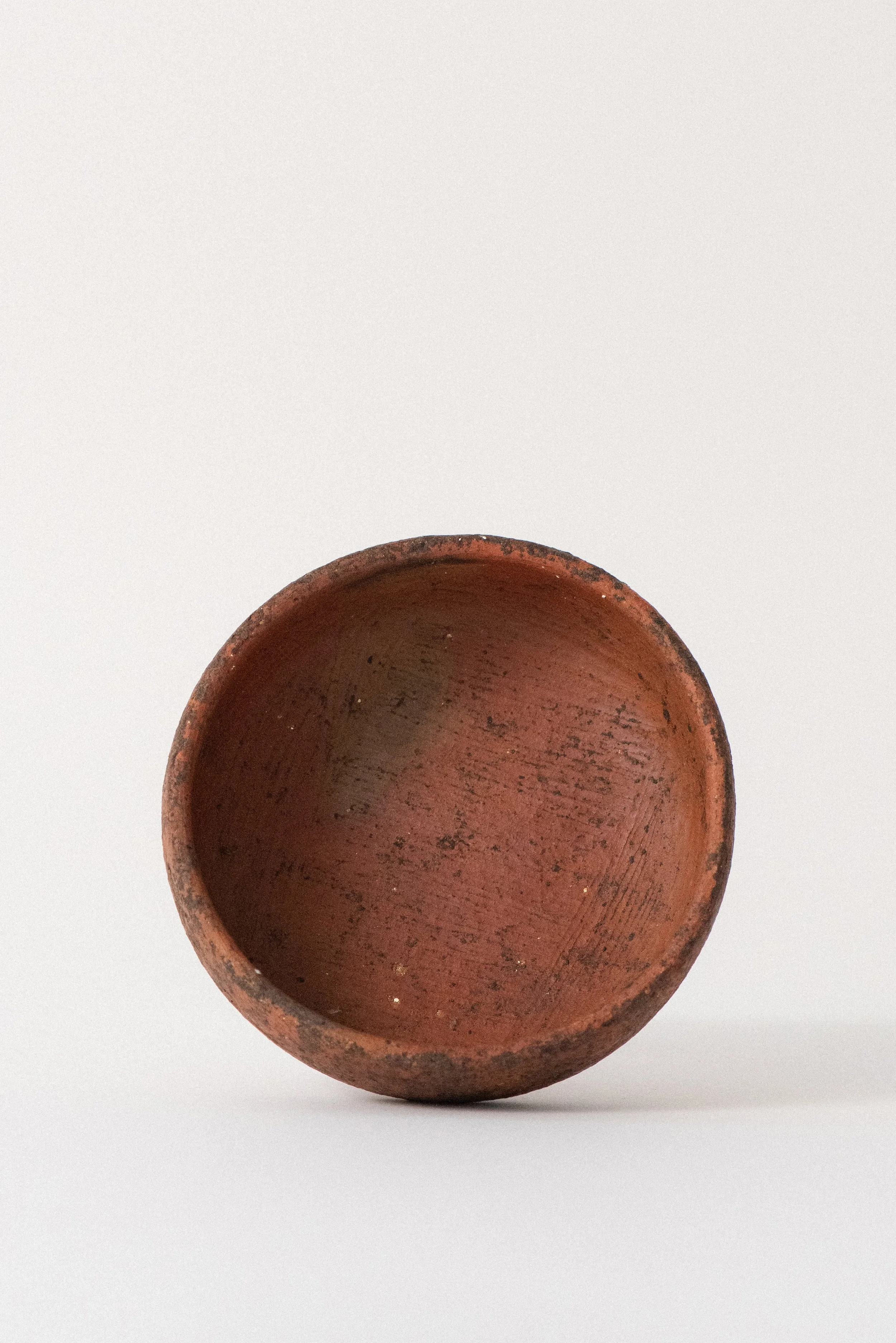 Top view of rustic handcrafted red clay pottery bowl from Oaxaca showing interior texture