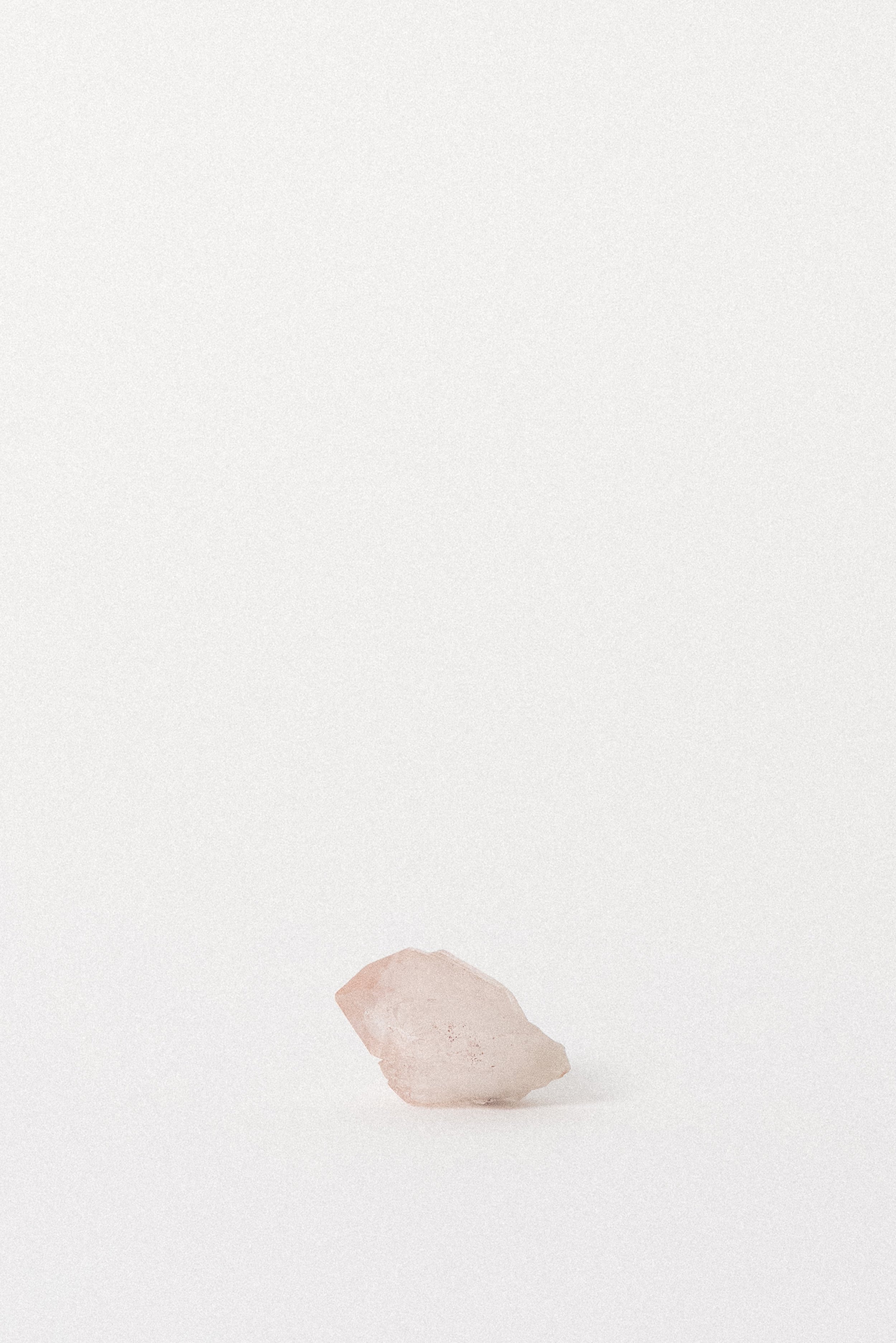 Side profile of Pink Quartz crystal showing soft rose tone and embedded fluorite