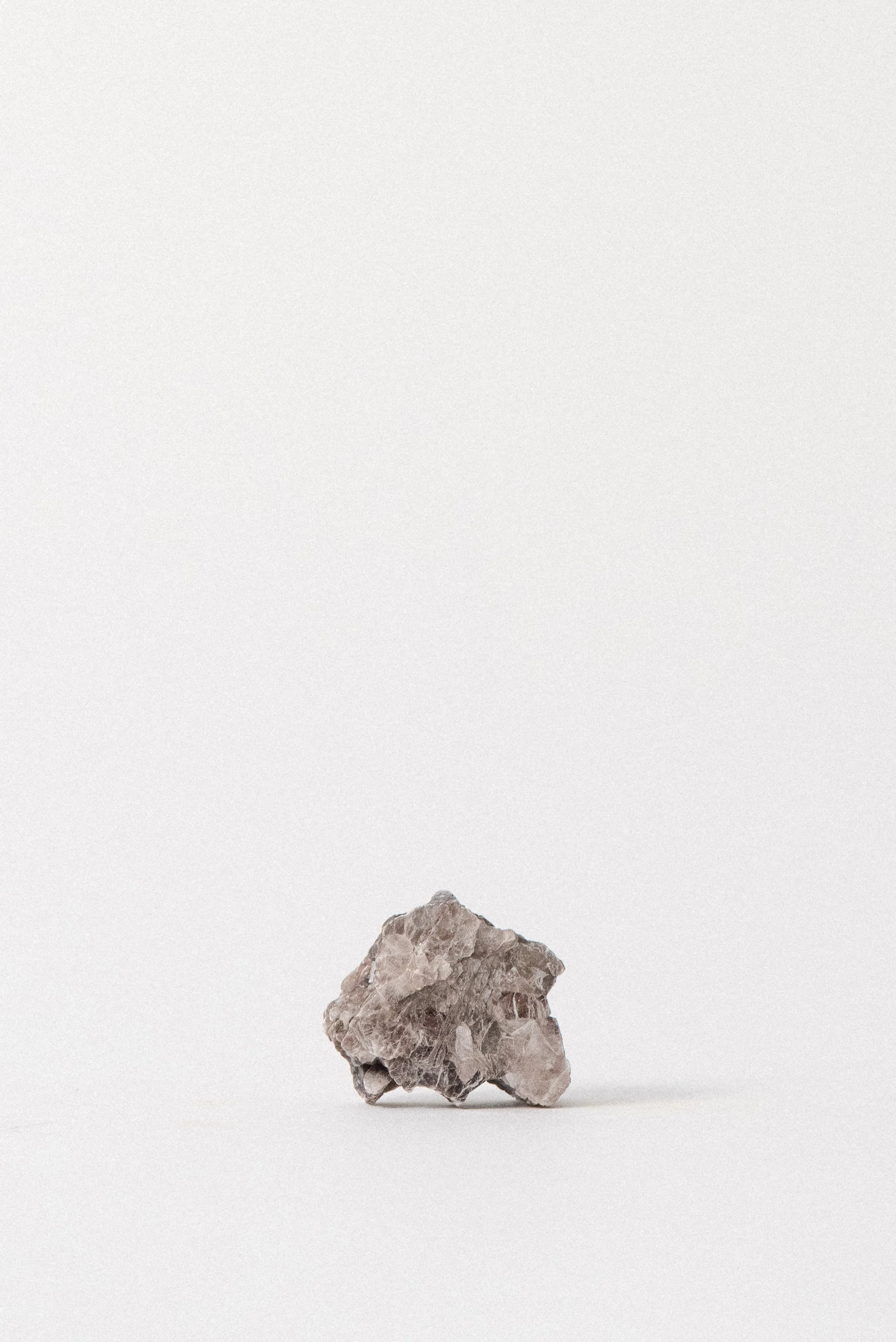 Raw muscovite mica specimen from Taquaral, Minas Gerais, Brazil. Silvery layered texture, photographed on a neutral background. Available from Crystal Voyager.