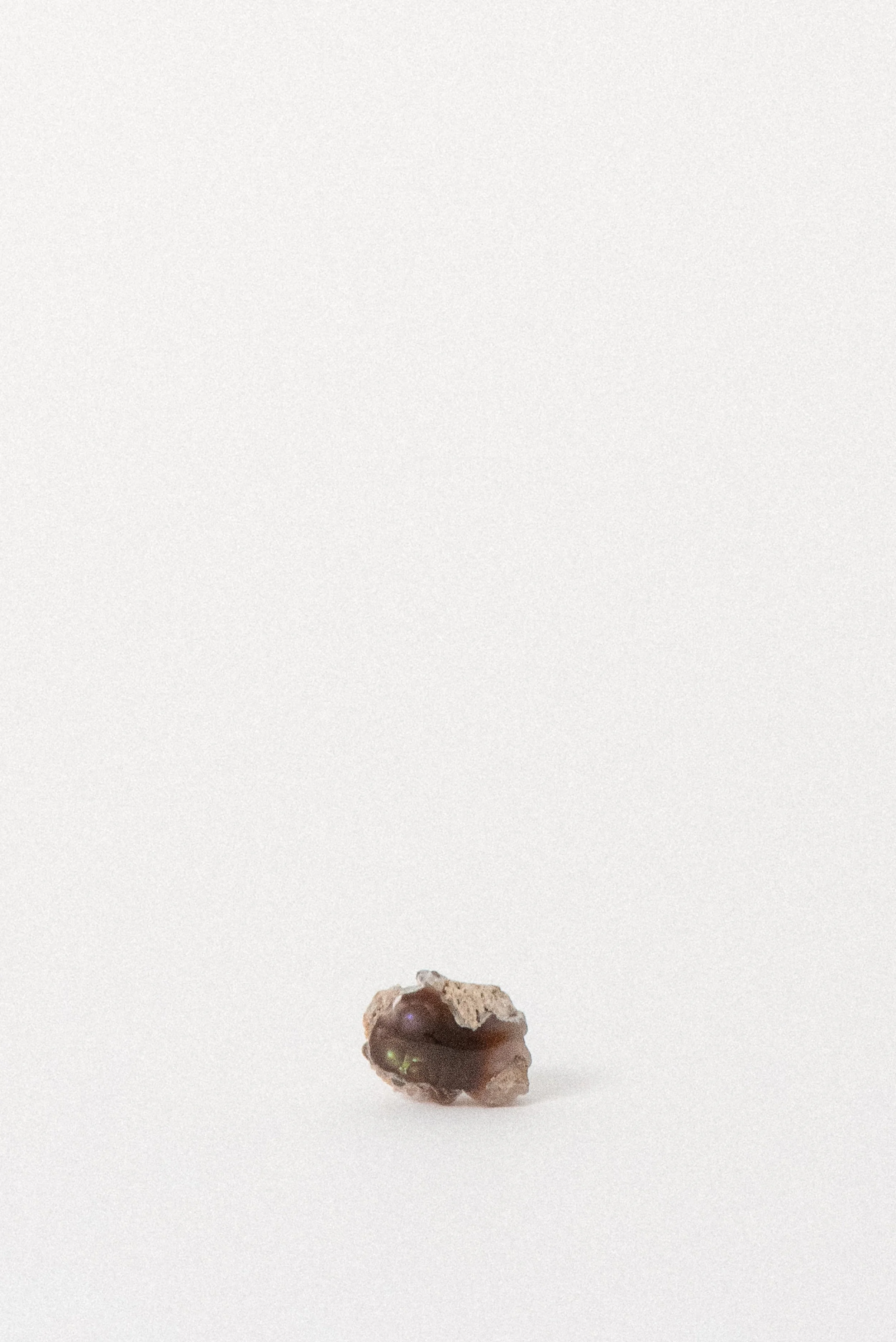 Fire Agate from Agua Caliente, Mexico with visible reddish body and iridescent flash.
