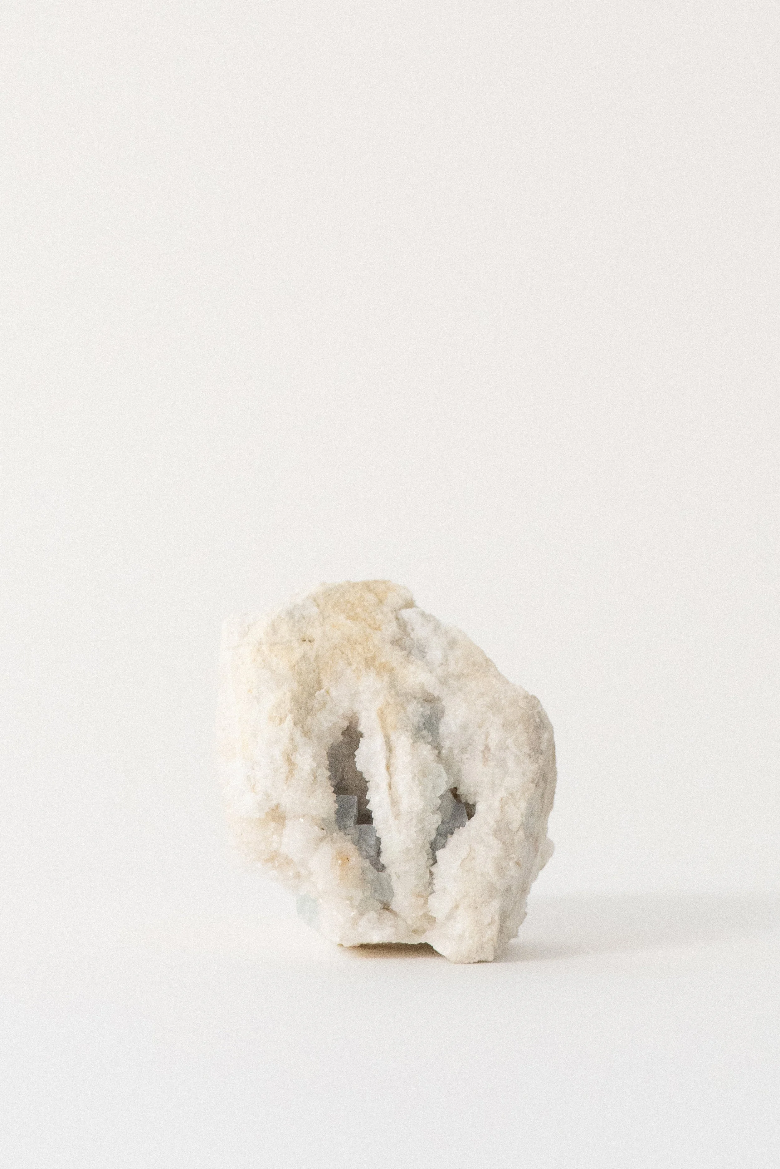 Pale aqua fluorite cubes embedded in white crystalline matrix from Hansonburg Mining District, New Mexico, photographed on white background