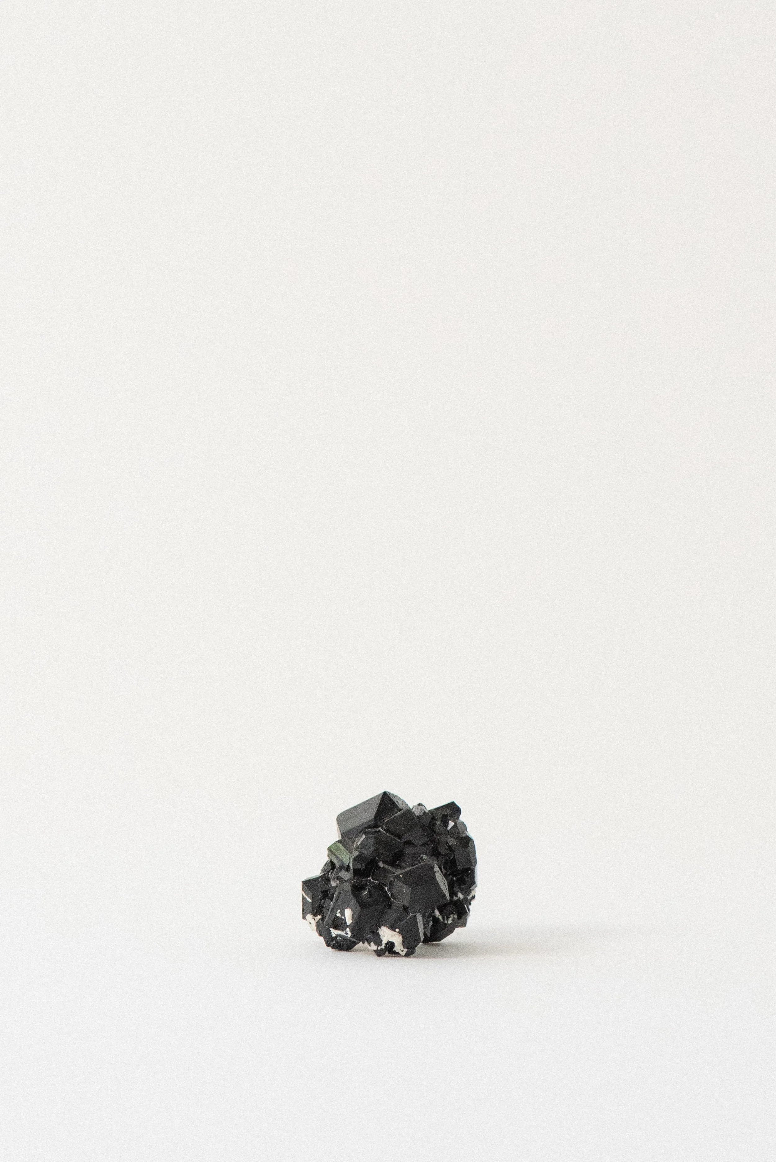 Alternate angle of a black tourmaline cluster from Erongo Mountain, Namibia, highlighting multiple geometric terminations and the piece’s natural crystal matrix.