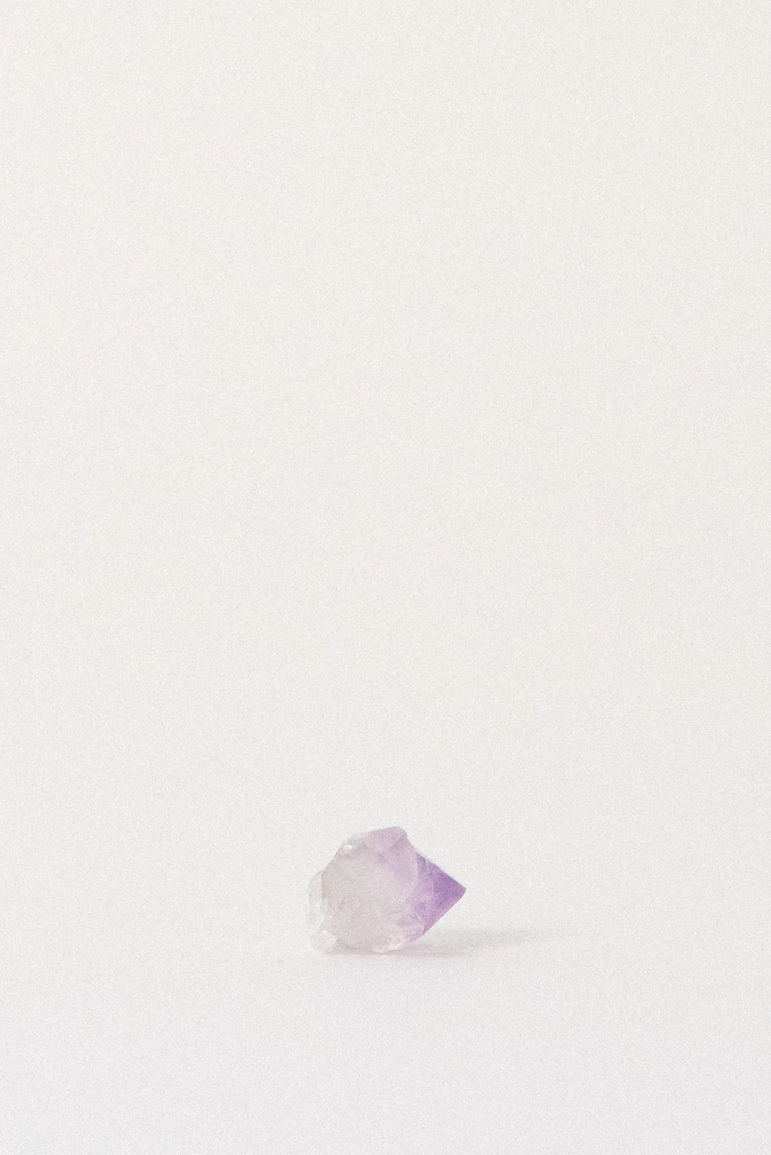 Natural amethyst point with light violet-to-clear gradient, photographed on white background; ethically sourced from Jackson’s Crossroads, Georgia