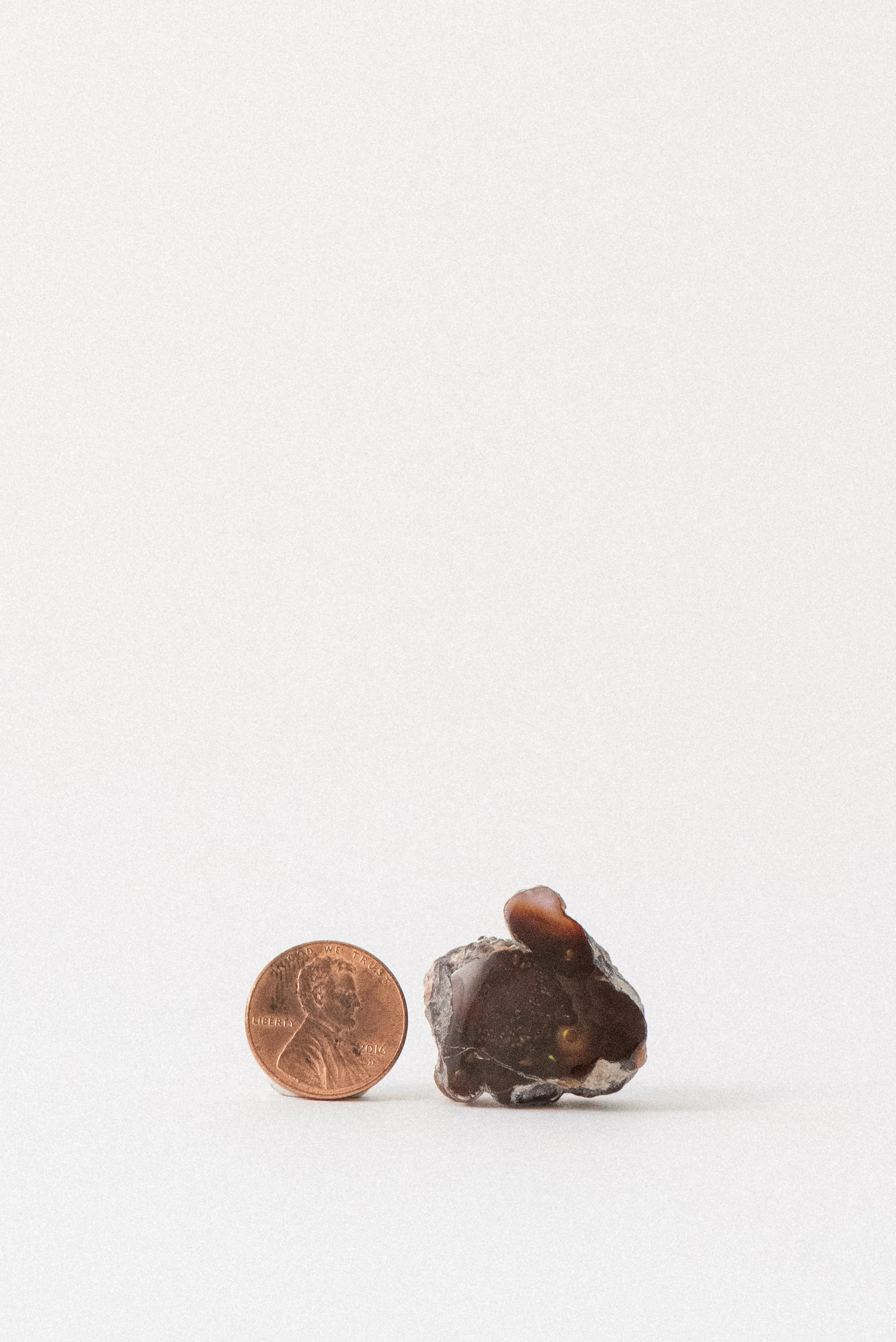 Mexican fire opal from Agua Caliente with penny for size comparison