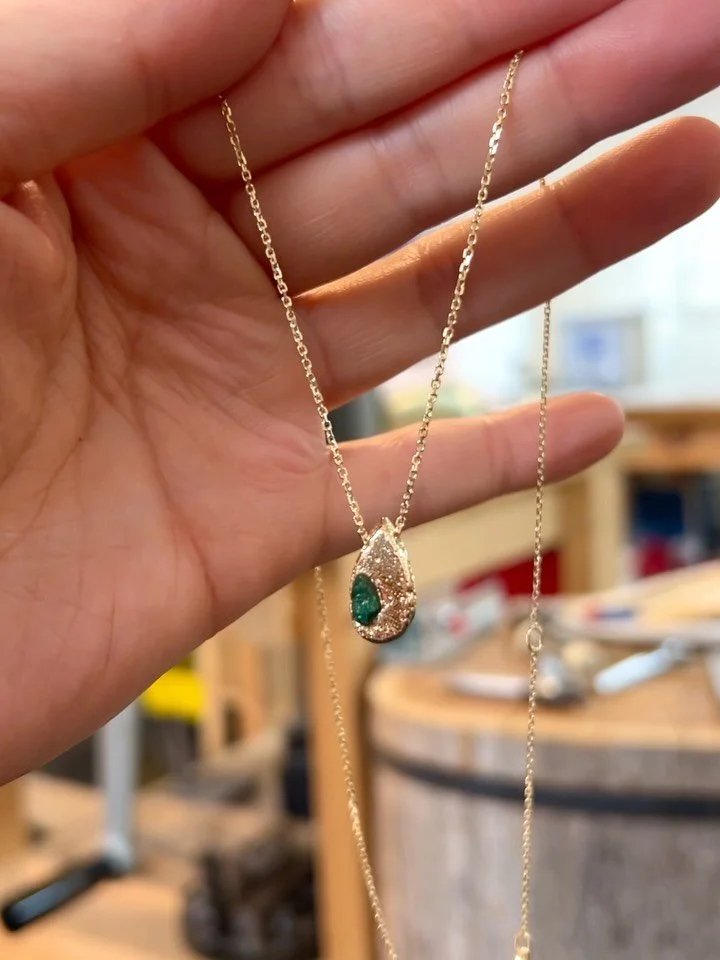 Mel&rsquo;s emerald gemstone broke in her engagement ring, but rather than discarding the damaged stone, Kim asked if it was possible to repurpose it. We decided to sand cast the emerald into gold, preserving fragments of the original gemstone and cr