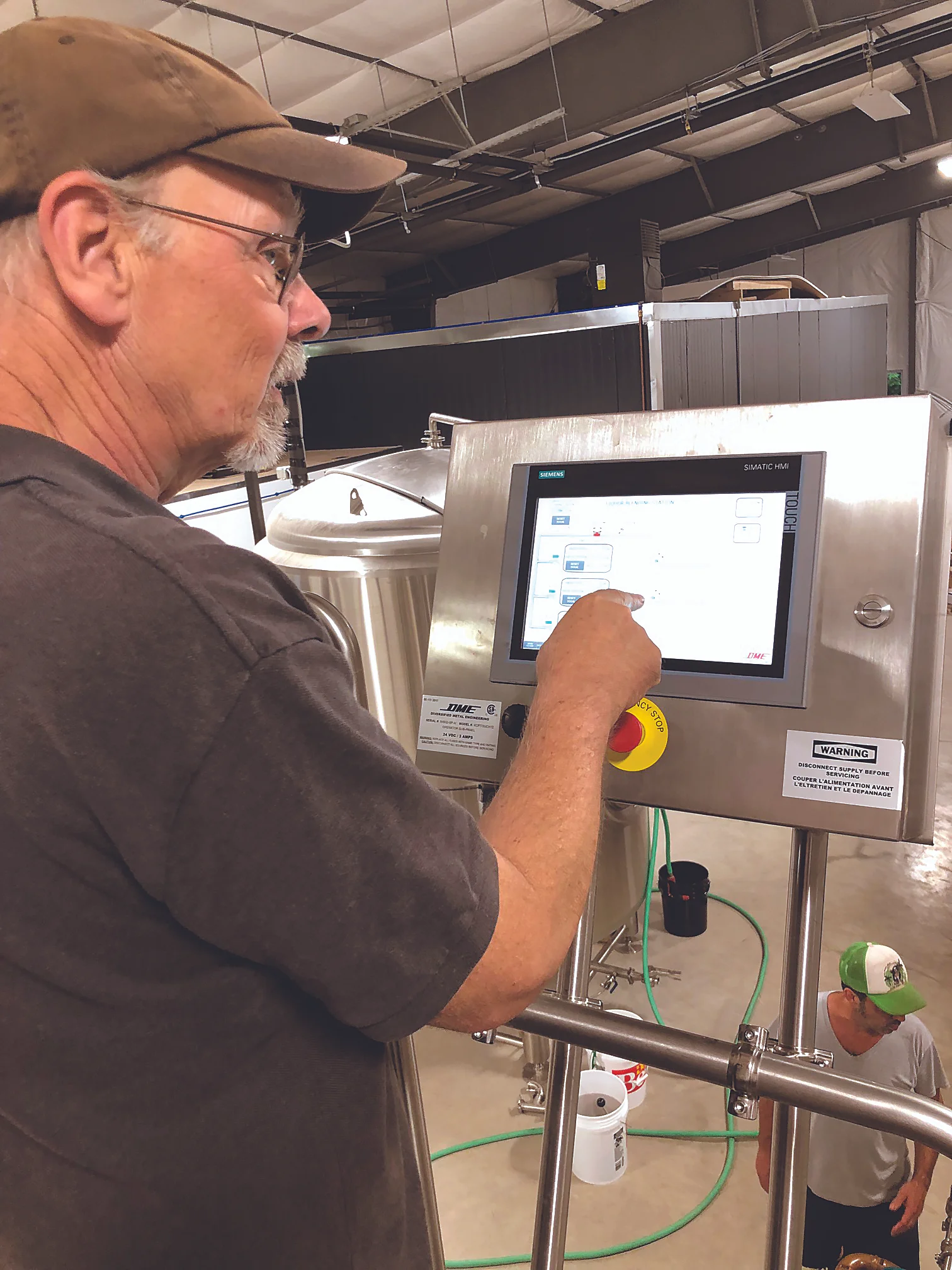 AT THE HELM David Walton demonstrates Upward Brewery’s brew tank digital controls. Art Steinhauer photo