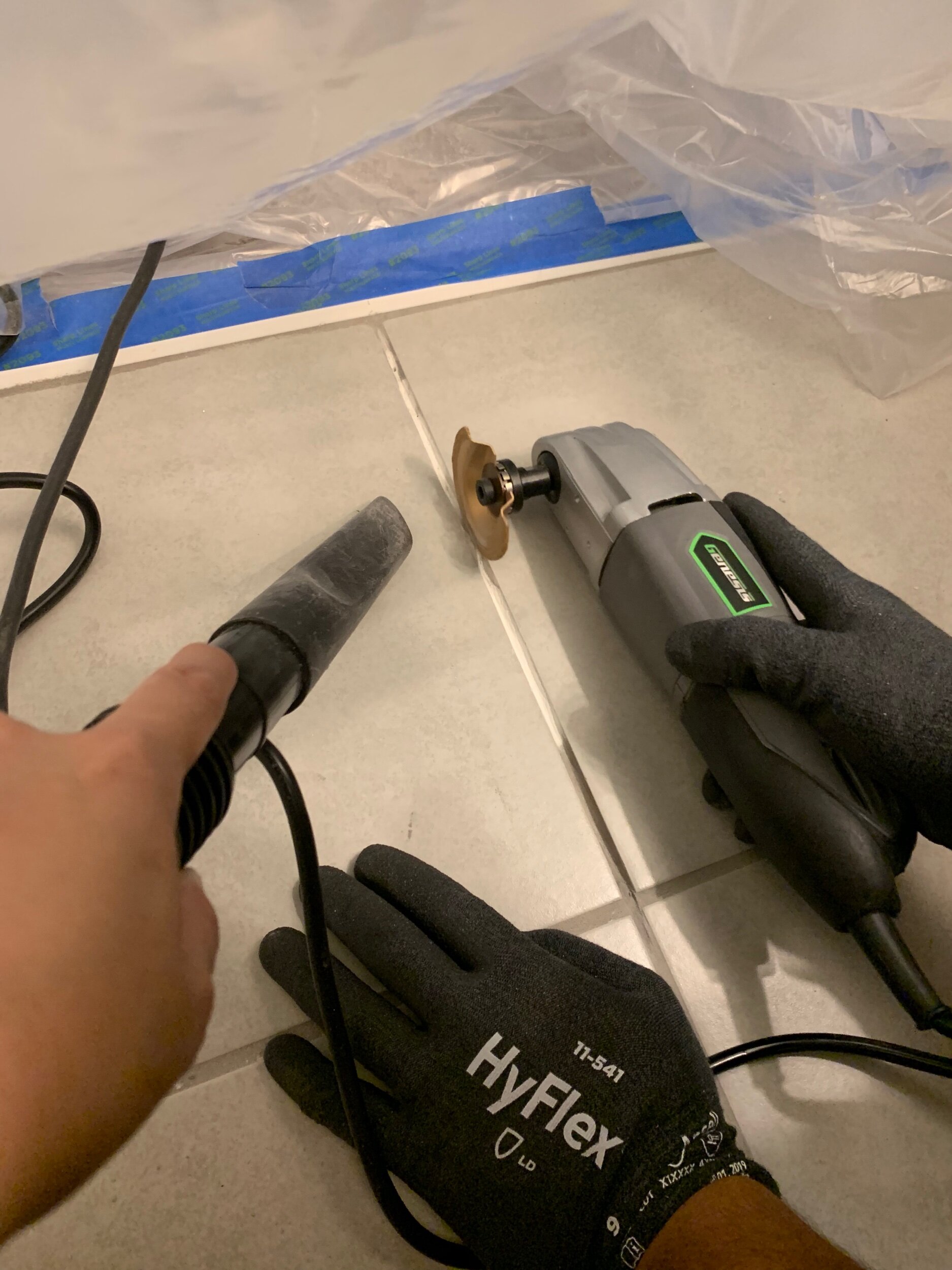Using the shop vac right next to the oscillating tool helps capture more dust.