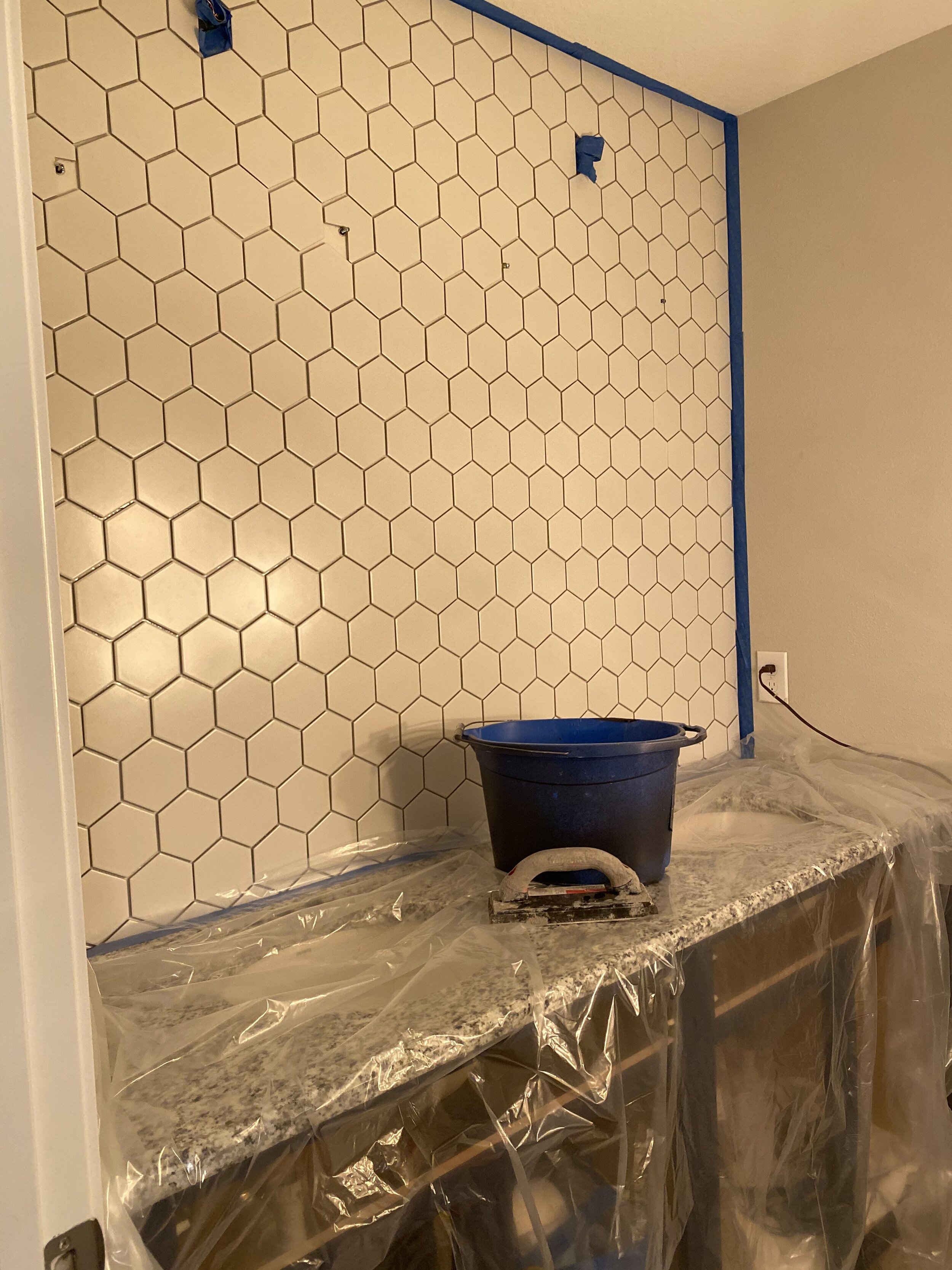 All the tile is cut and in place, walls taped off, and we’re ready for grout!