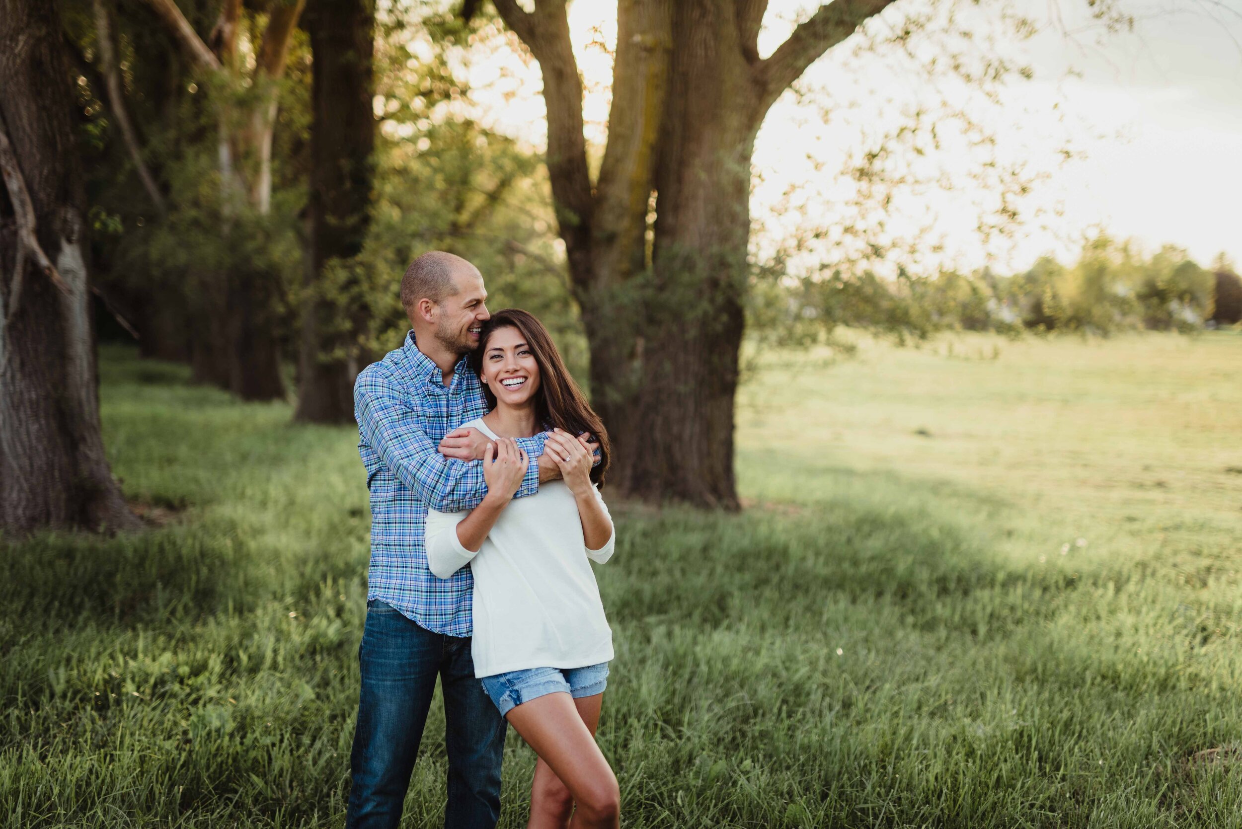Lauren and Zach’s summer engagement photo session in Lafayette, Indiana at golden hour in an natural field