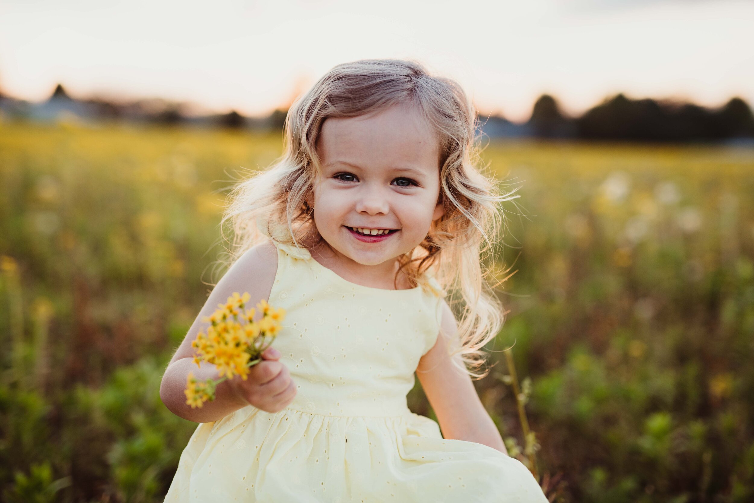 family photography at sunset in a yellow wildflower field in Lafayette, Indiana with Kelly McPhail
