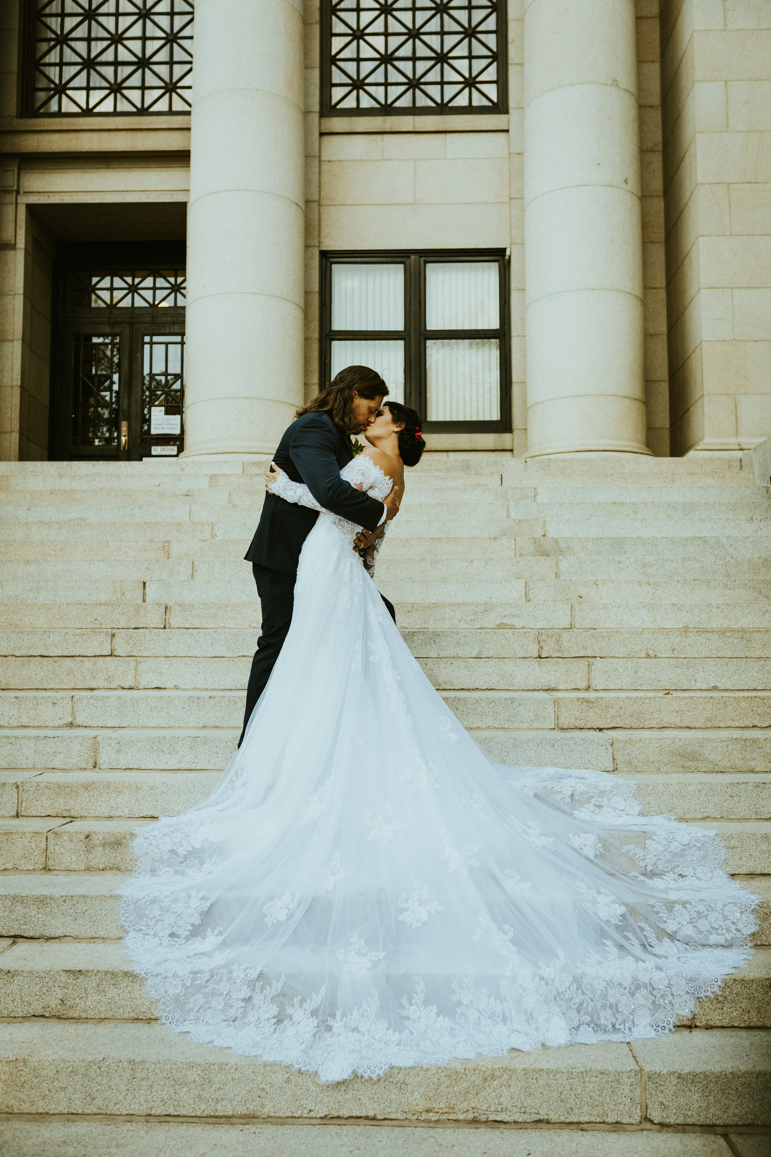 Grand highland hotel downtown courthouse square prescott arizona wedding wedding dress train cathedral train bride and groom kiss-1.jpg