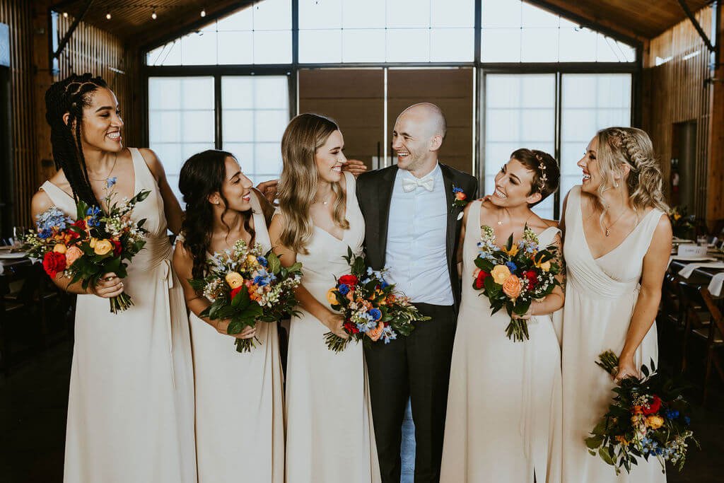 Groom standing with bridesmaids at The Paseo in Arizona