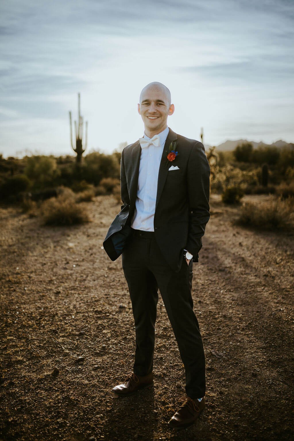 Groom standing in the Arizona desert