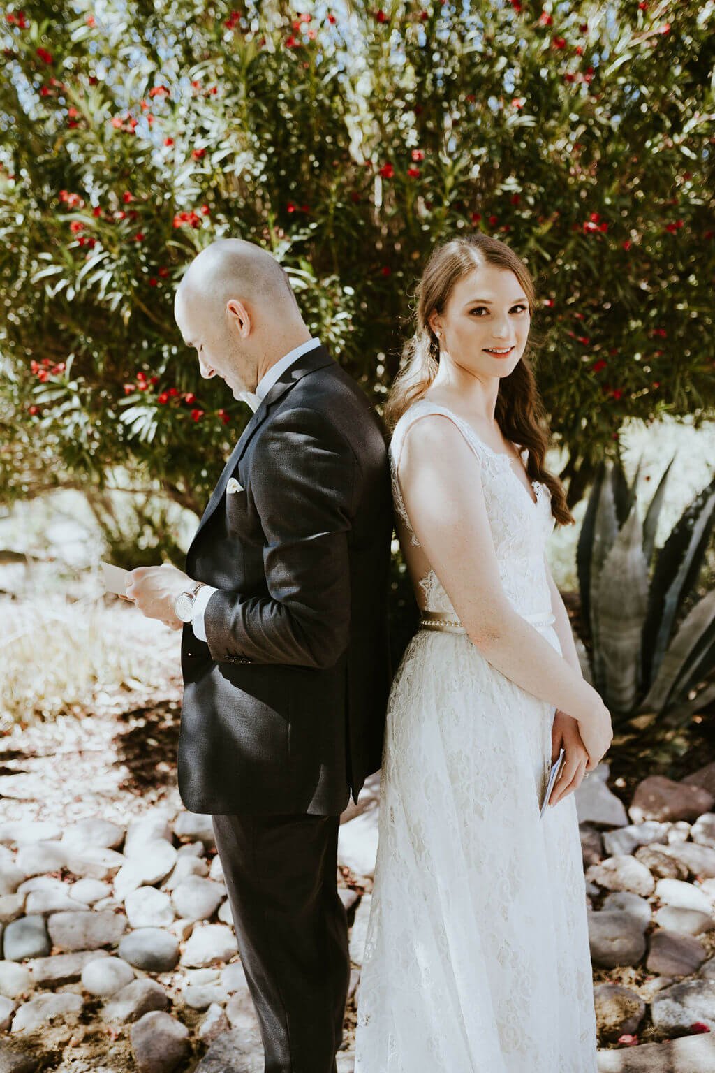 Bride and groom standing back to back in the Arizona desert