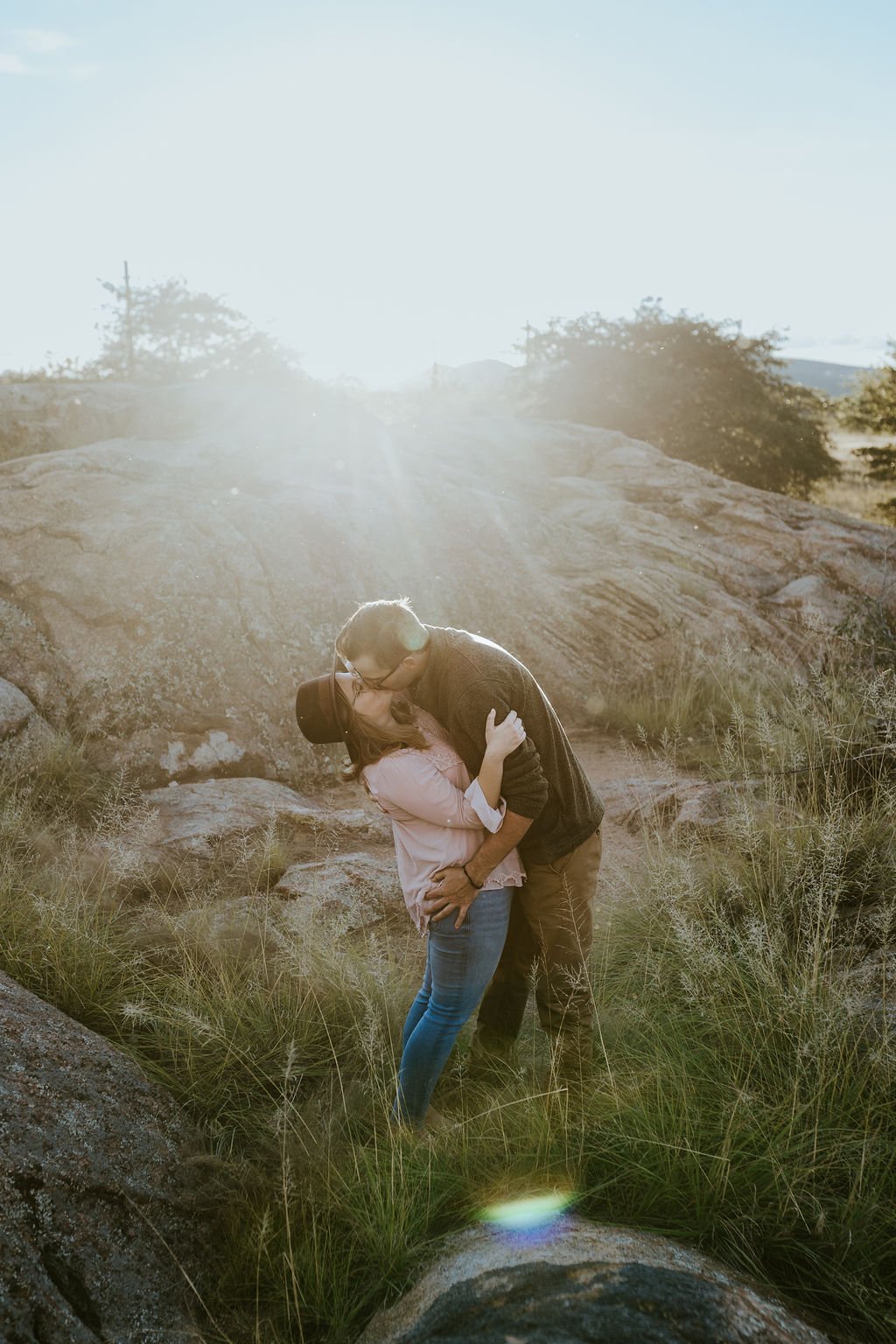 Couple dips for a kiss during Arizona engagement photo session