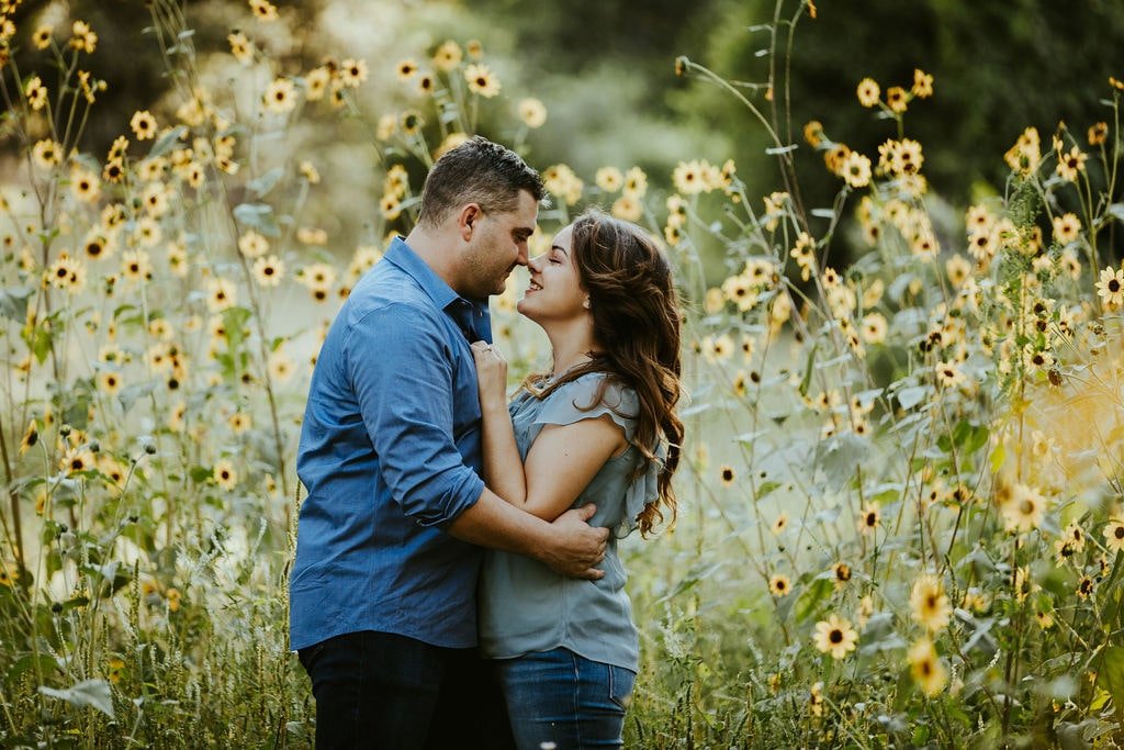 Couple hugging in the wildflower fields during couple photo session in Prescott, AZ