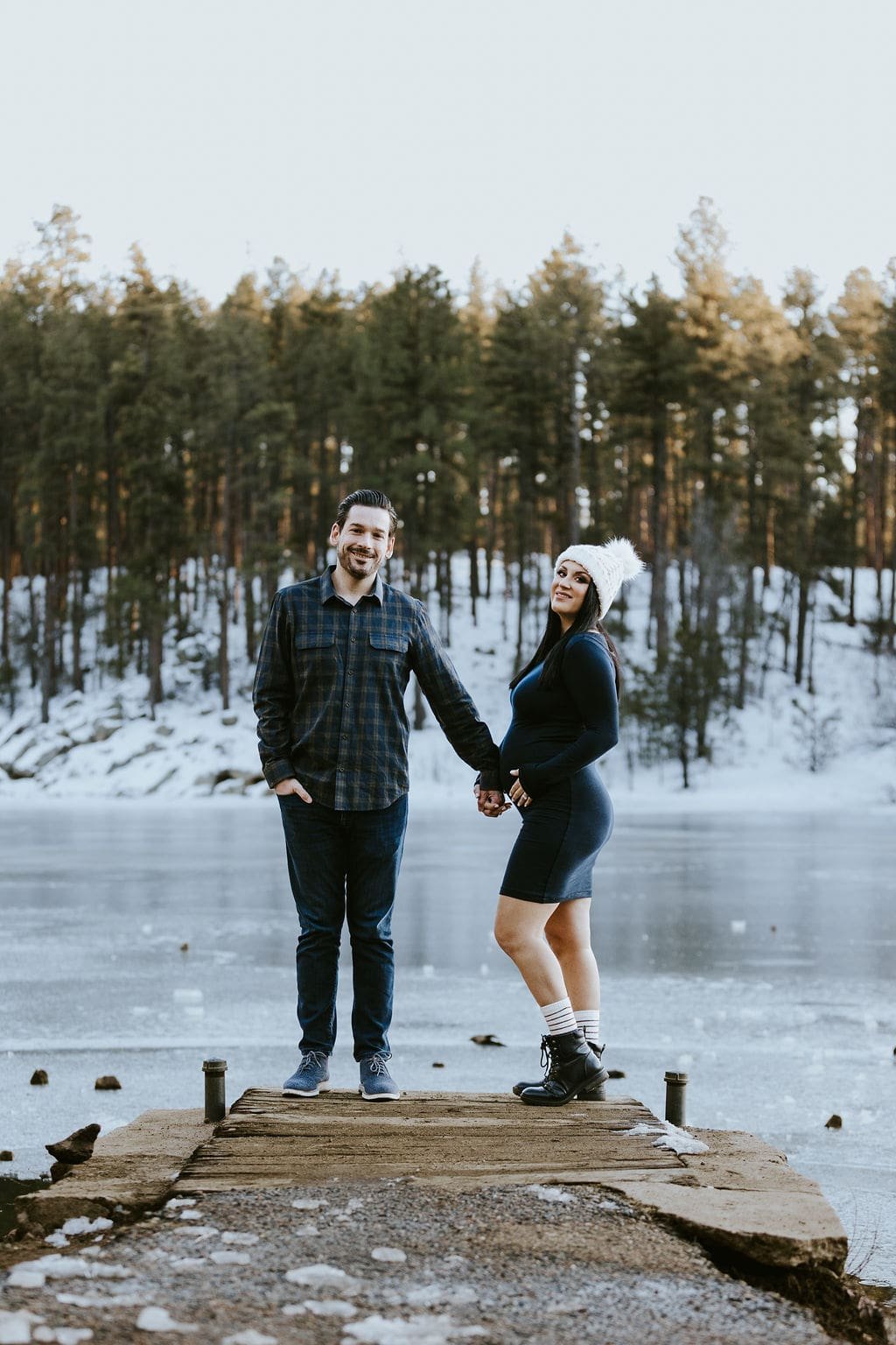 Couple holding hands during maternity photos in Prescott