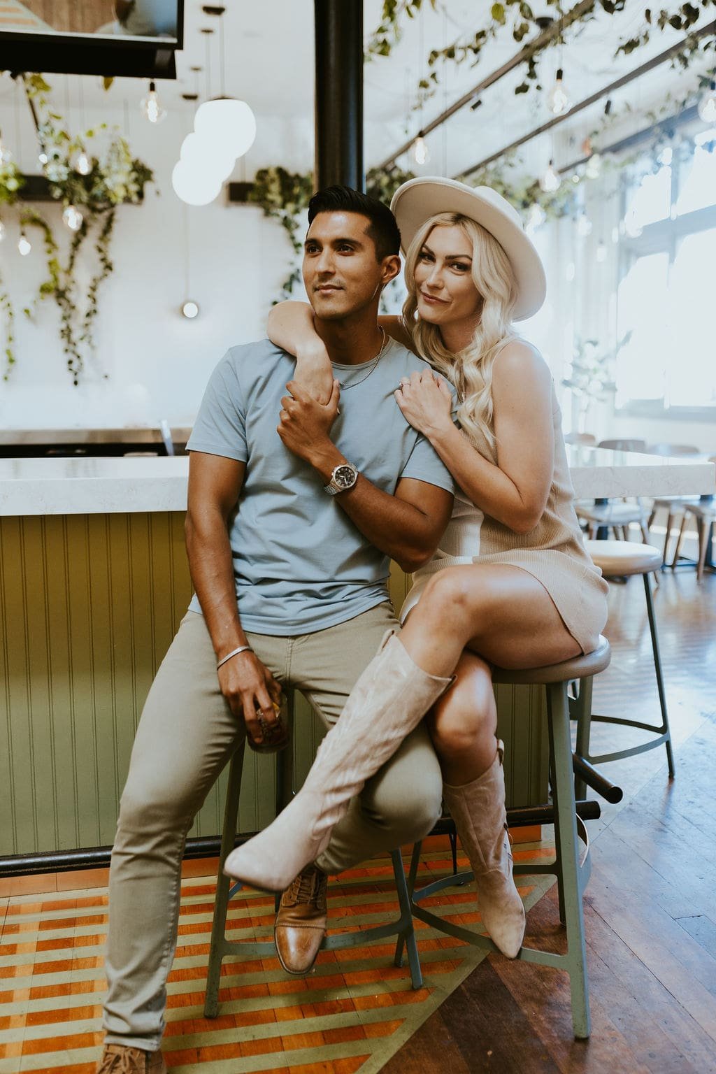 Couple sitting at a coffee shop during engagement photos in Prescott