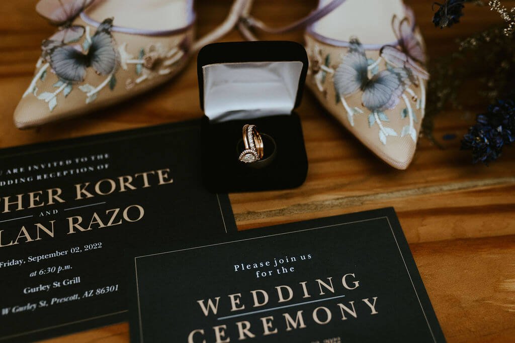 Wedding invitations with rings and bride's shoes